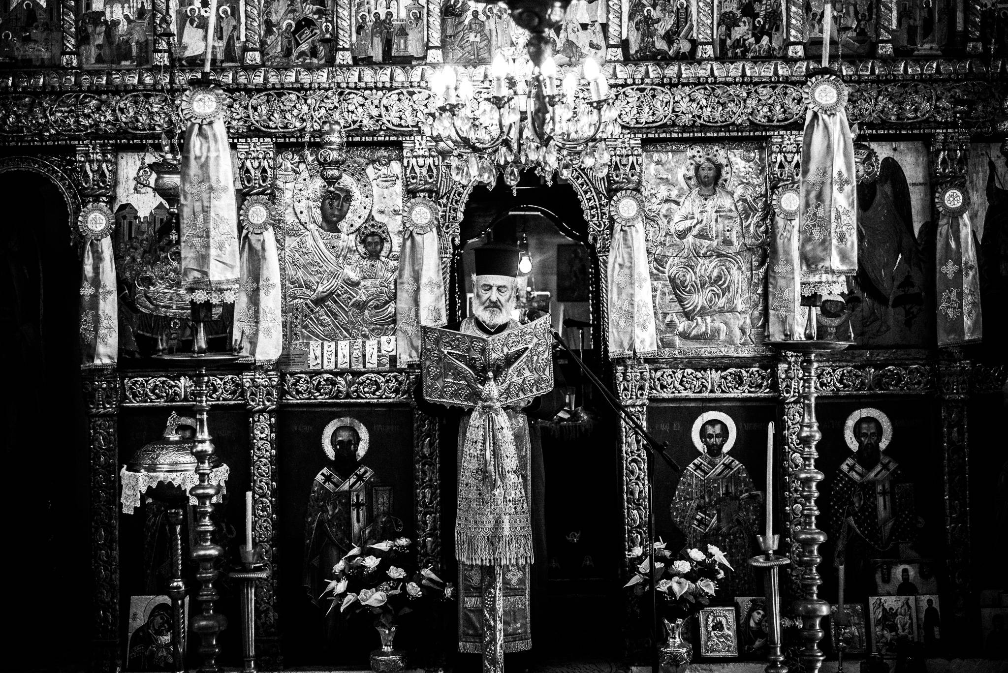 Papa-Yannis in the church in Olympos, Karpathos, Greece. Black and white photography by George Tatakis