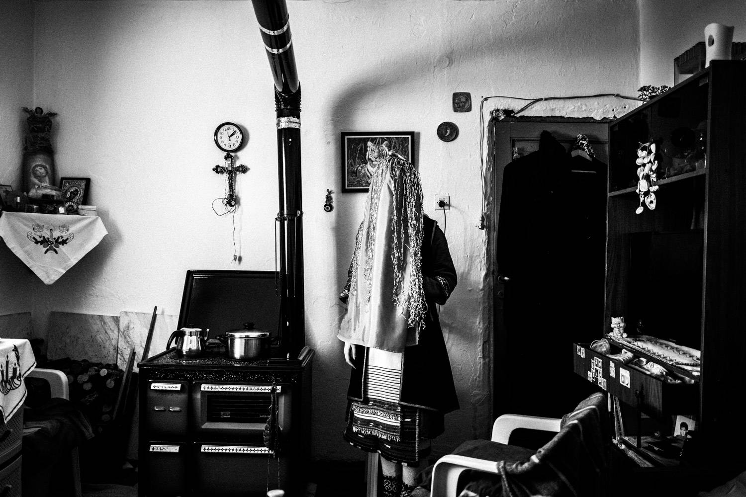 A vailed bride, wearing the traditional attire, inside a local home. Volax, Drama, Macedonia, Greece. Black and white photograph by George Tatakis