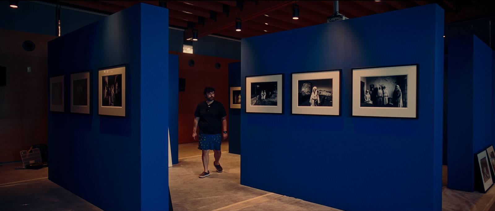 George Tatakis walking through the Caryatis Delta Chios exhibition installation at the Chios Mastic Museum.