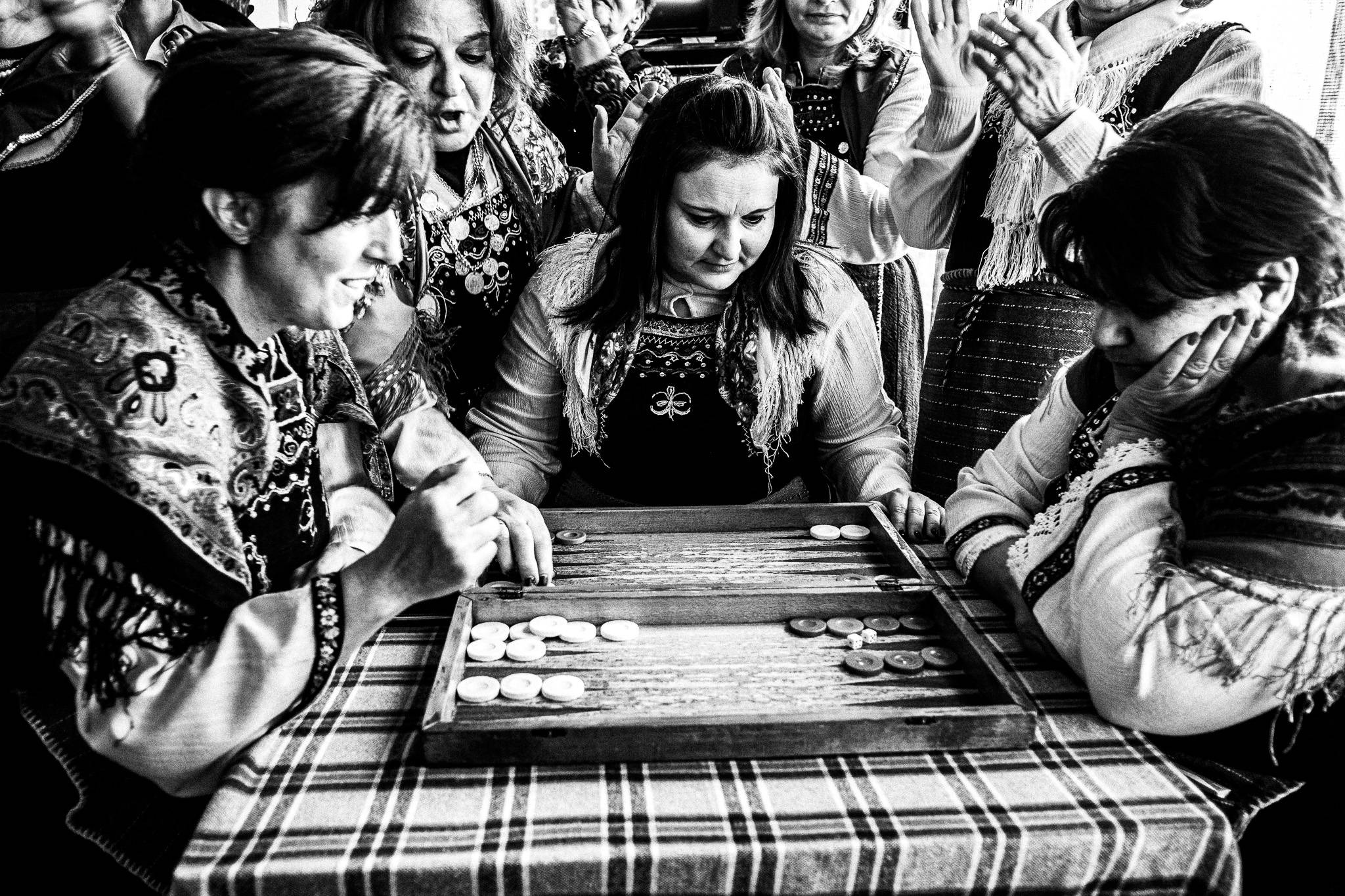 Playing backgammon at the local café, Pagan Christmas customs of Northern Greece, by photographer George Tatakis