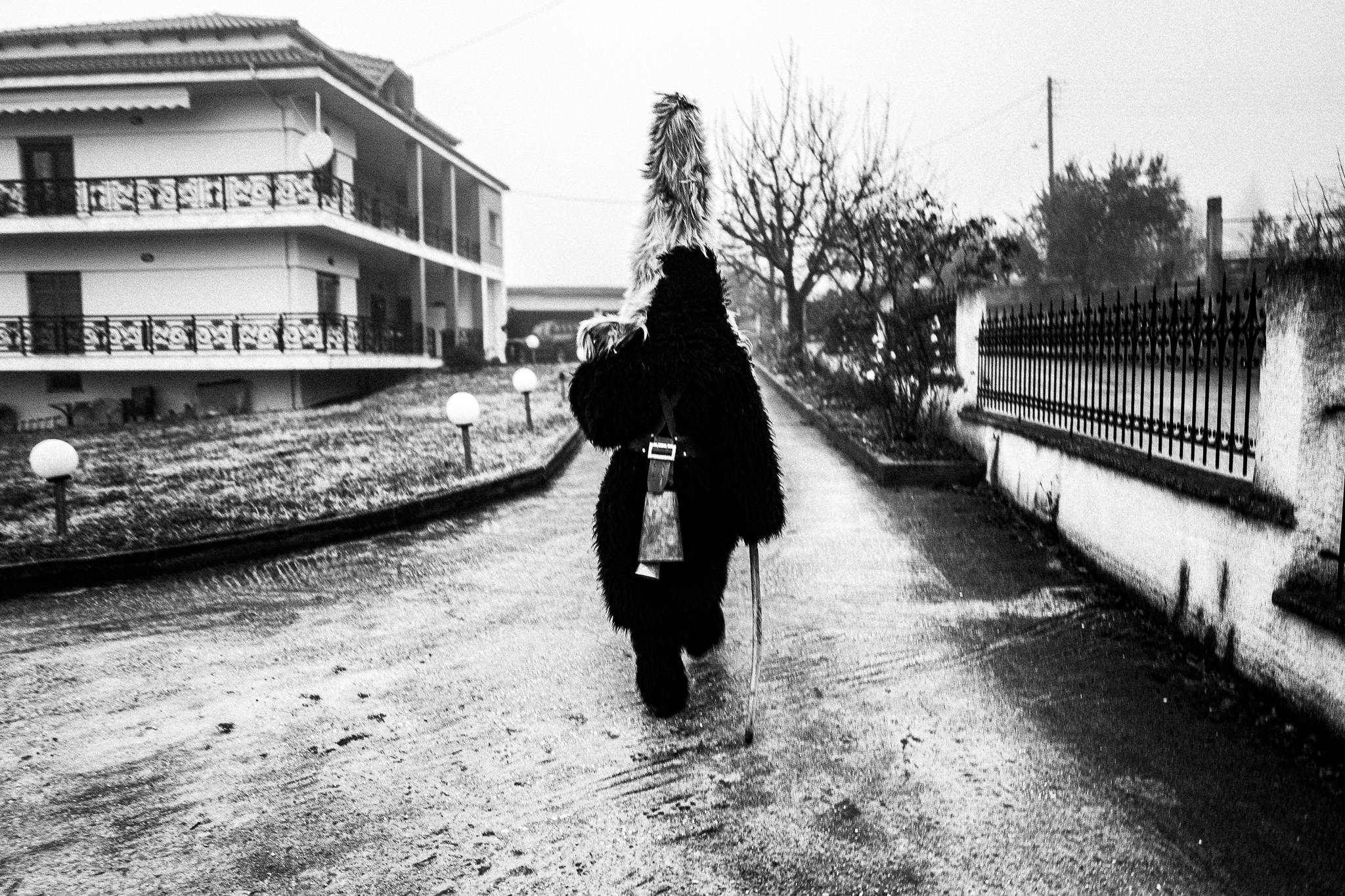 An Arapis visiting local houses around Monastiraki to give wishes, Pagan Christmas customs of Northern Greece, by photographer George Tatakis