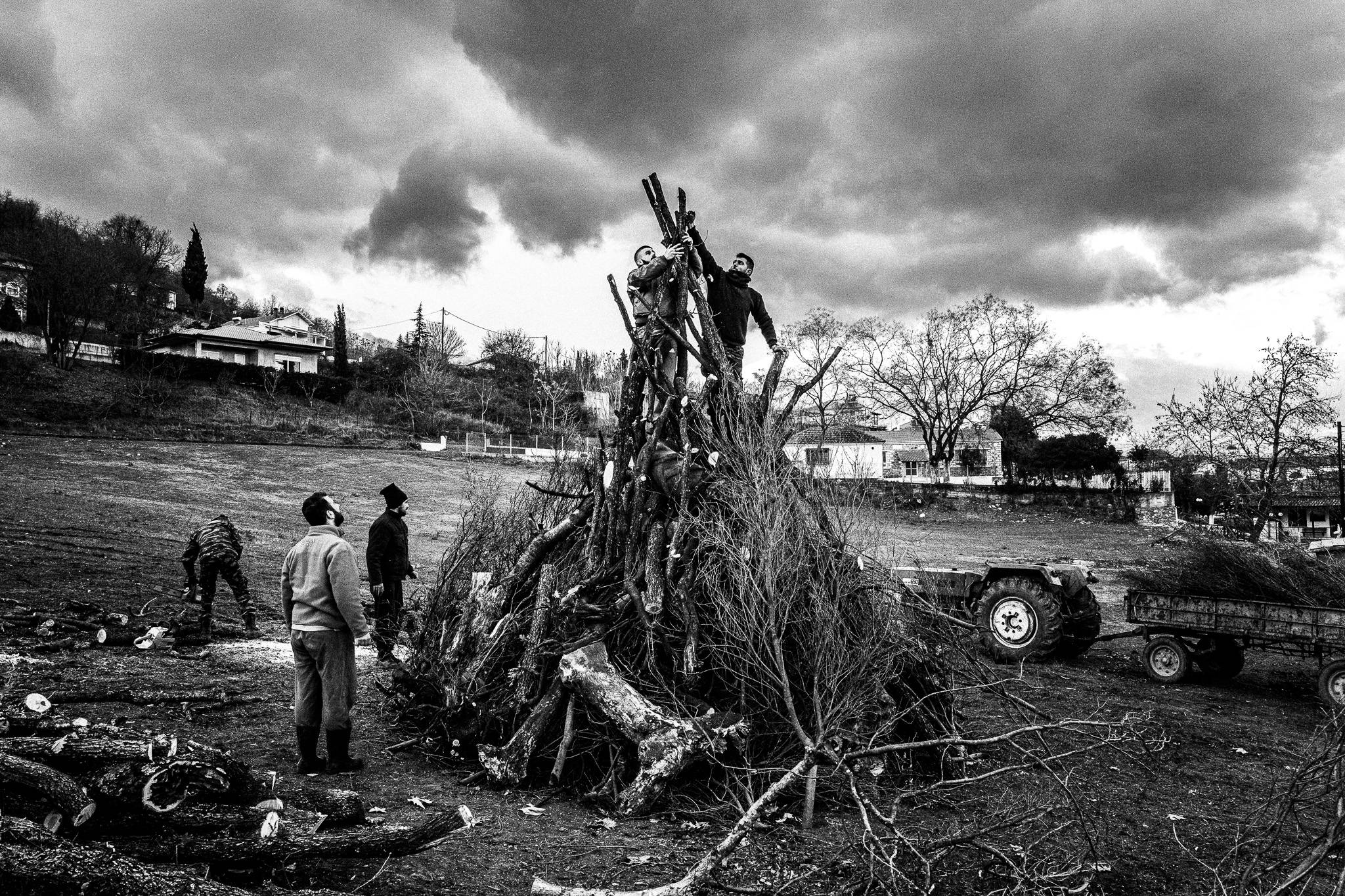 Building up the pile of woods, Pagan Christmas customs of Northern Greece, by photographer George Tatakis