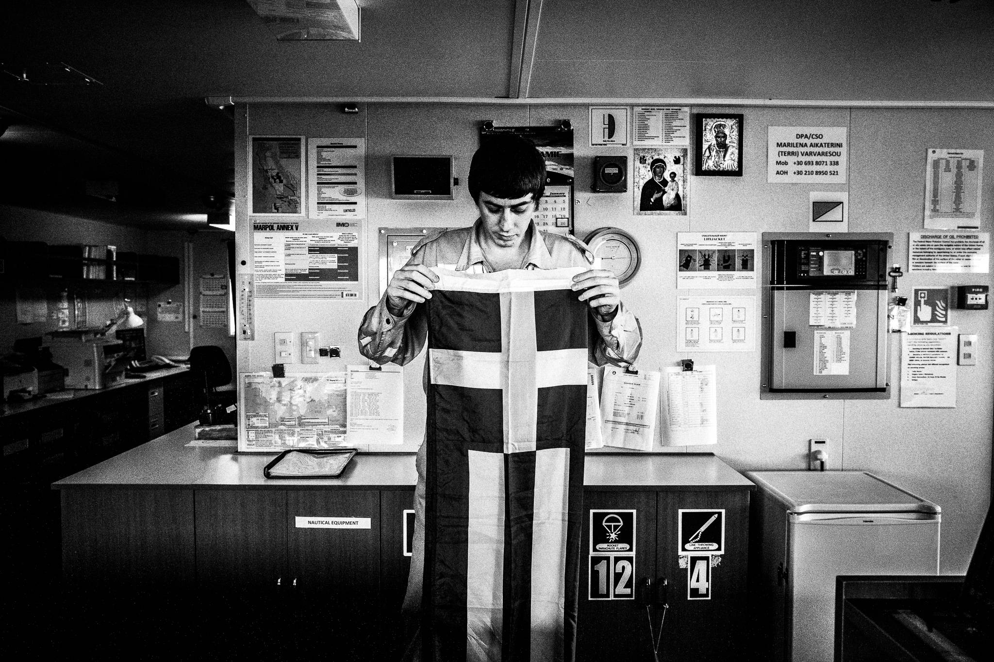 Anthony holding the Greek flag by photographer George Tatakis