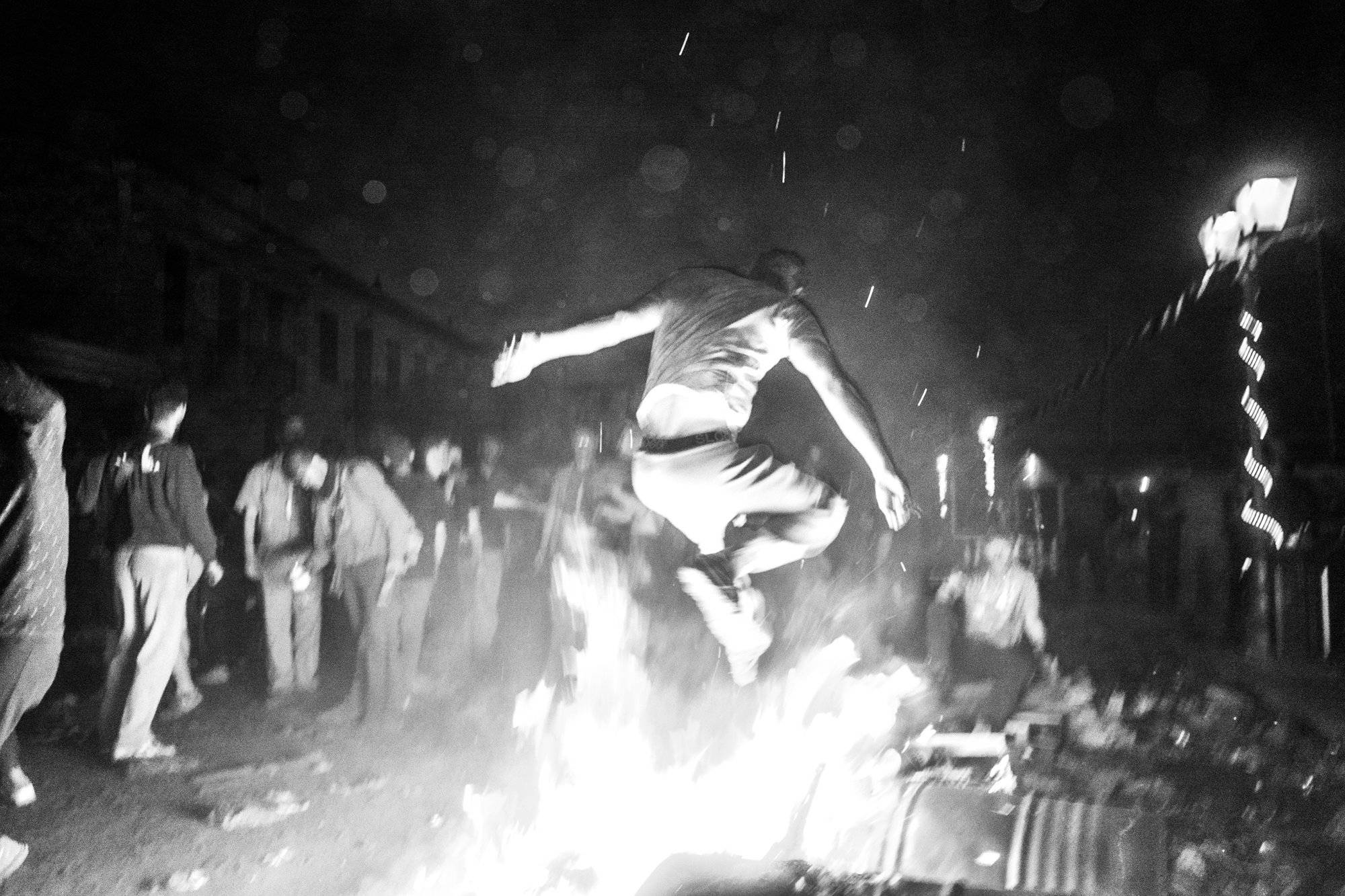 Jumping over a bonfire at the flour wars of Galaxidi, by photographer George Tatakis