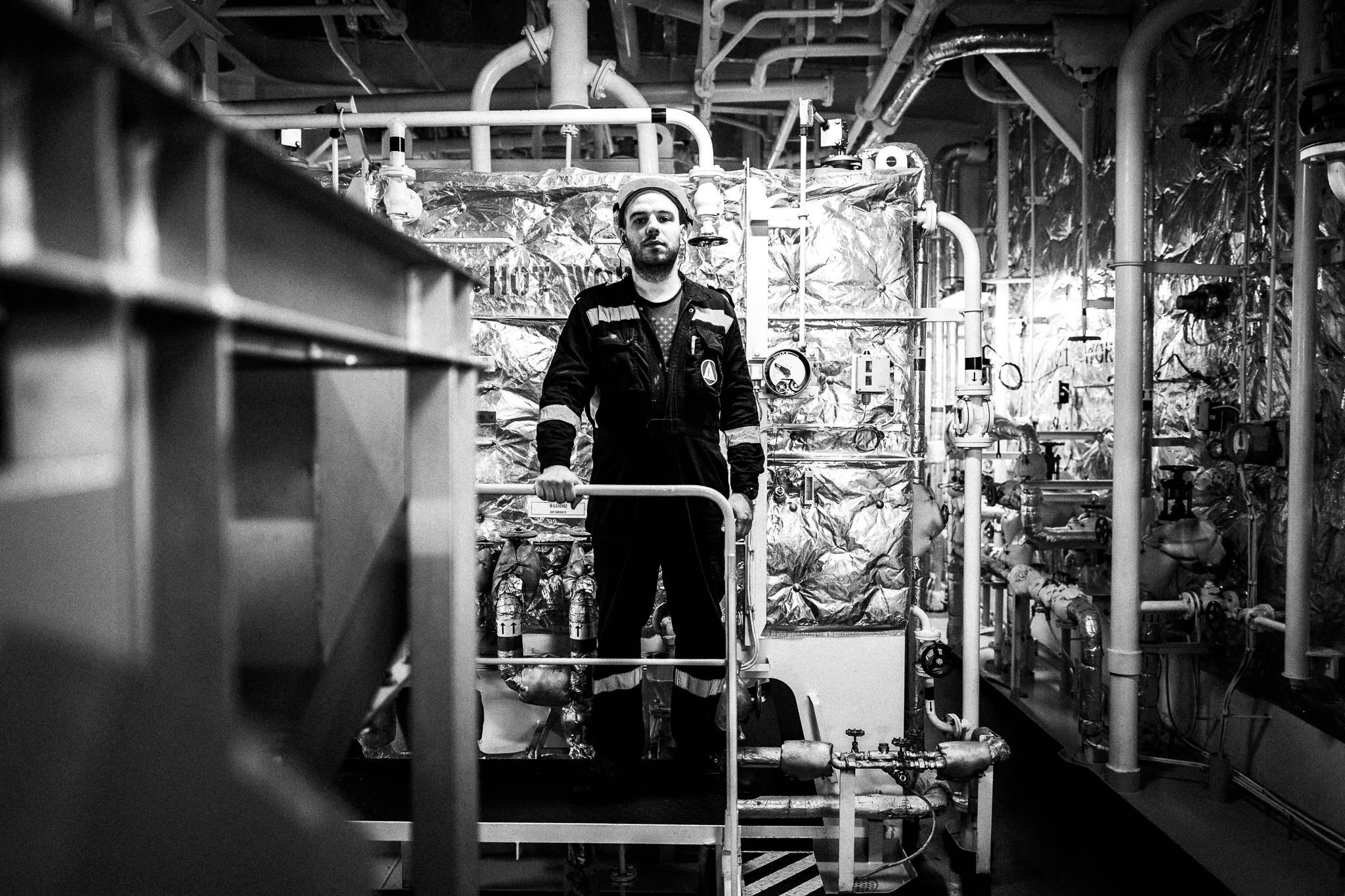 Engineer on vast oil tanks by photographer George Tatakis