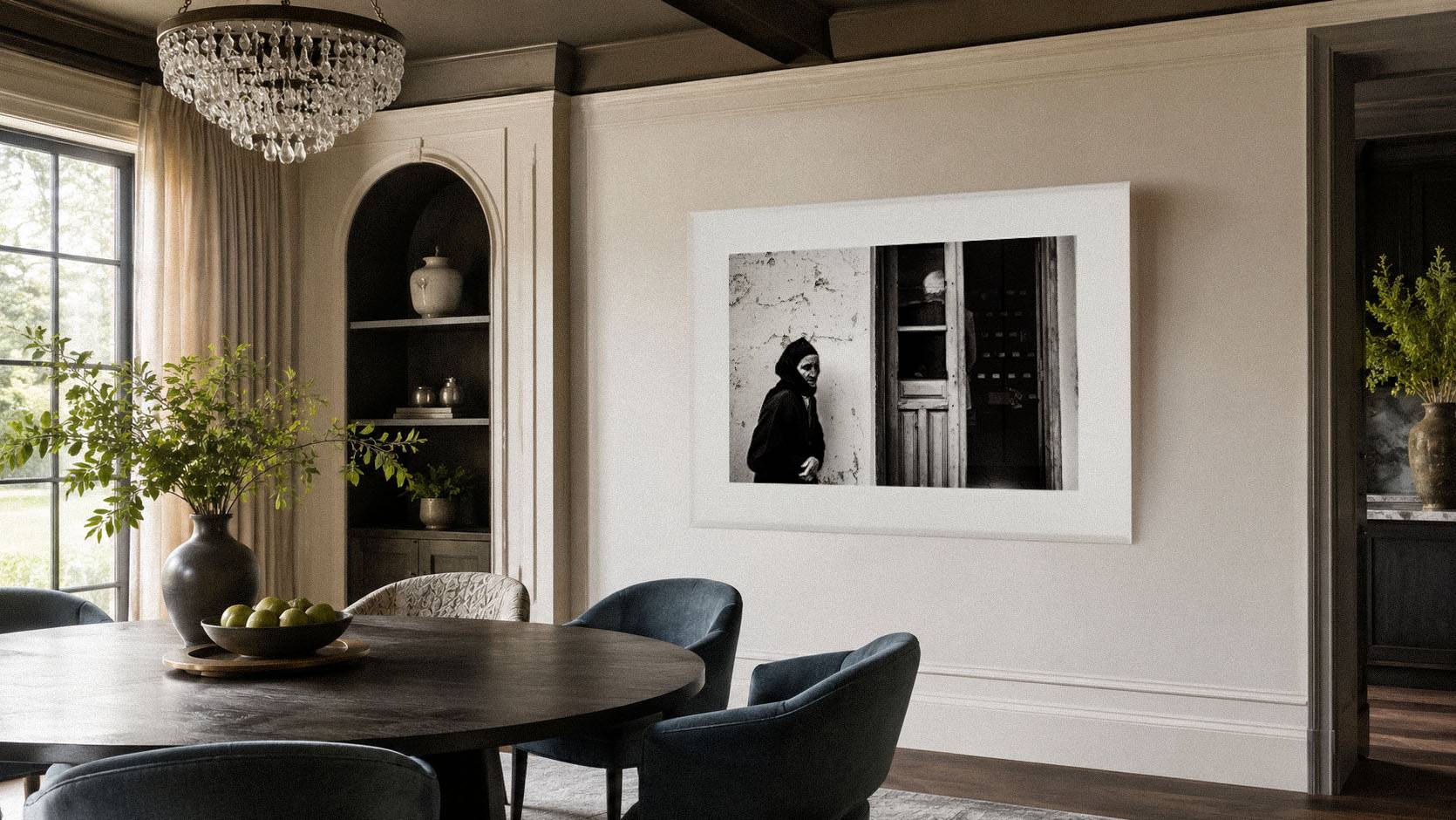 Large black-and-white fine-art photograph displayed in an elegant dining interior, illustrating how a museum-quality framed work can anchor a sophisticated space.