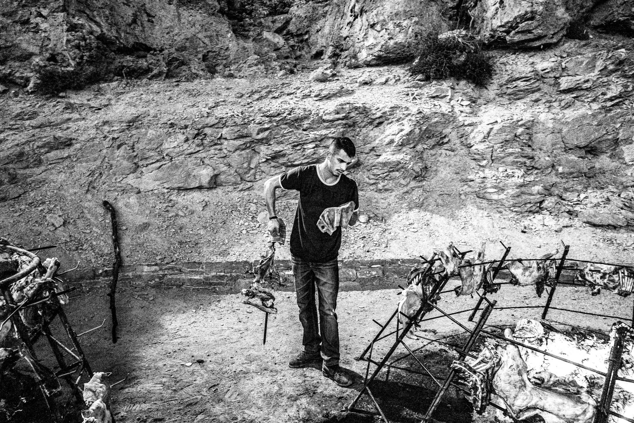 Preparing antikristo lamb, during the St Fanouris' church at Psiloritis, Anogia, Rethymnon, Crete, by photographer George Tatakis