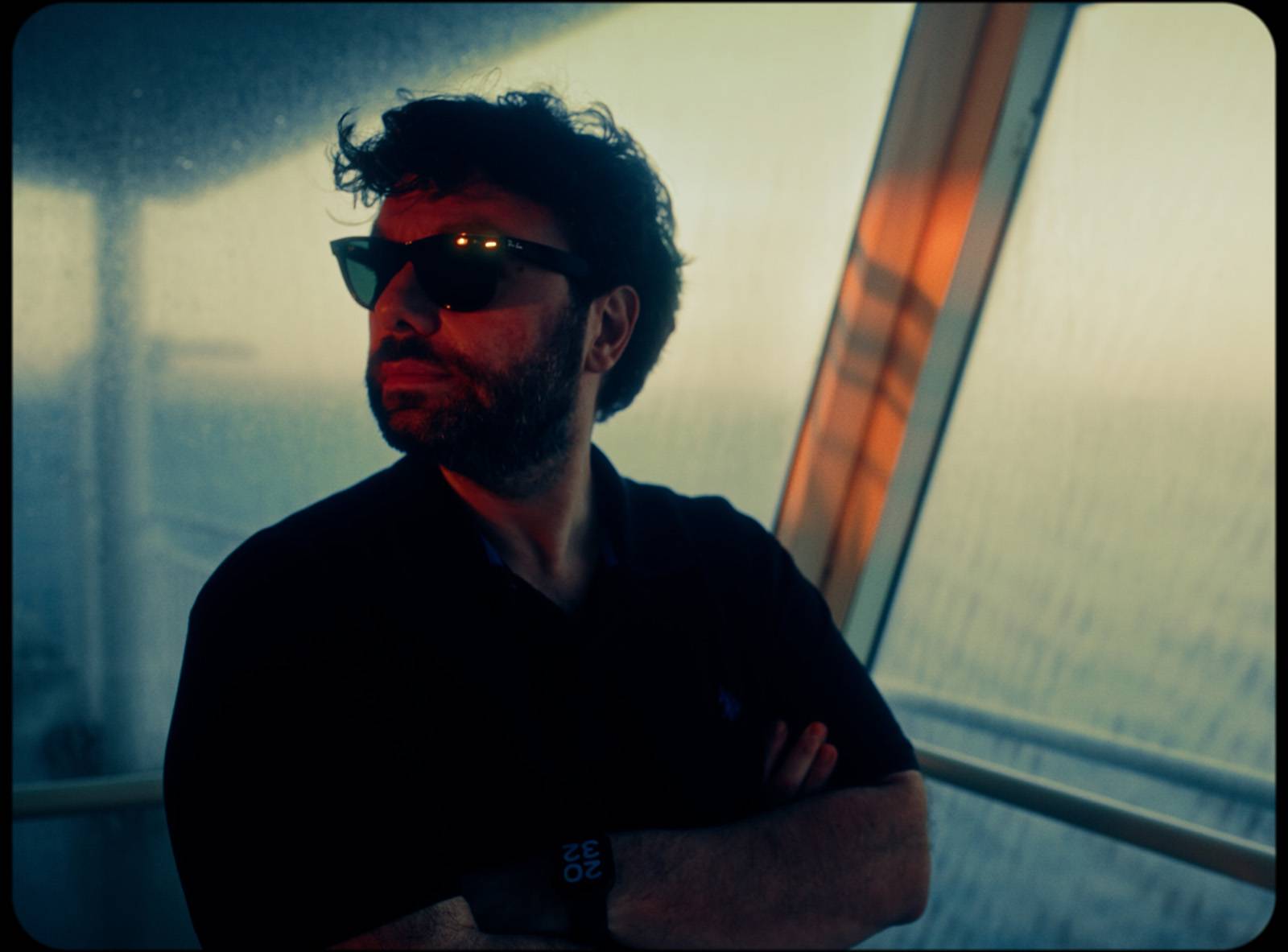 George Tatakis on the ferry to Chios, looking out through the window during the journey to the Caryatis exhibition.