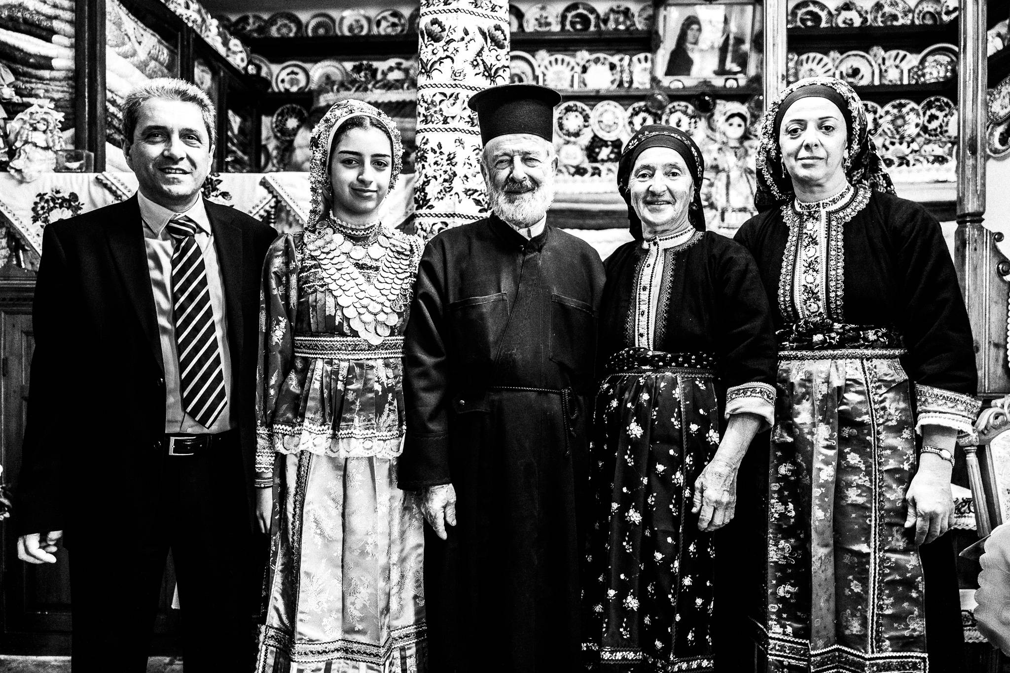 The family of the local priest inside their traditional home. Olympos, Karpathos, Greece. 