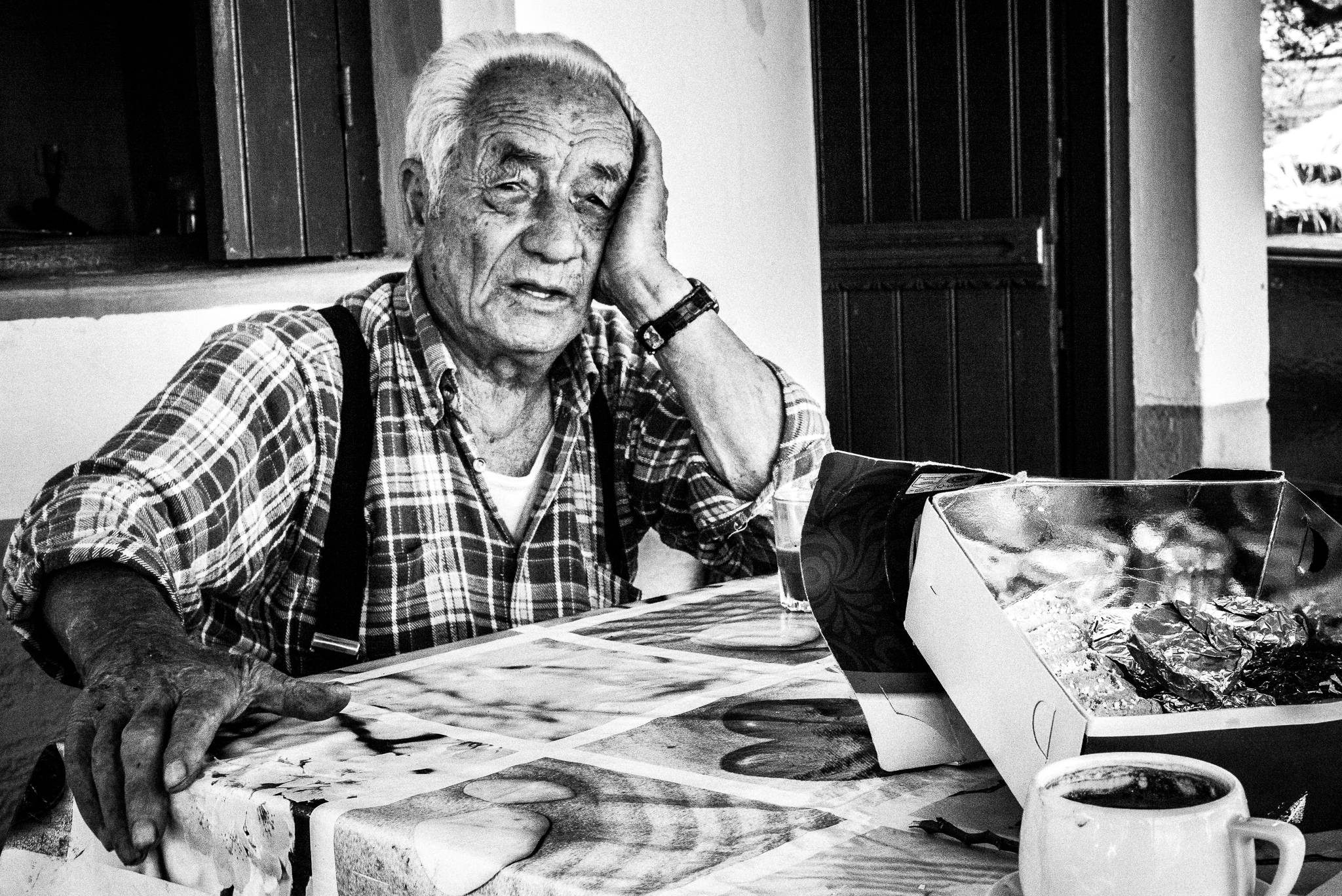 Having coffee at Olympos, Karpathos, Greece. Black and white photography by George Tatakis
