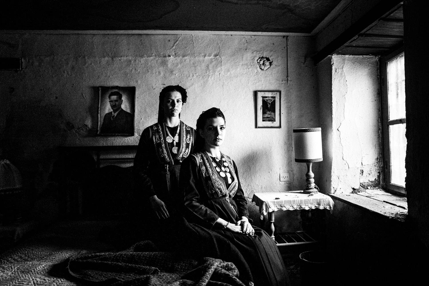 Sitting portrait of two women wearing the local Vlach costumes. Seli, Imathia, Macedonia, Greece. Black and white photograph by George Tatakis
