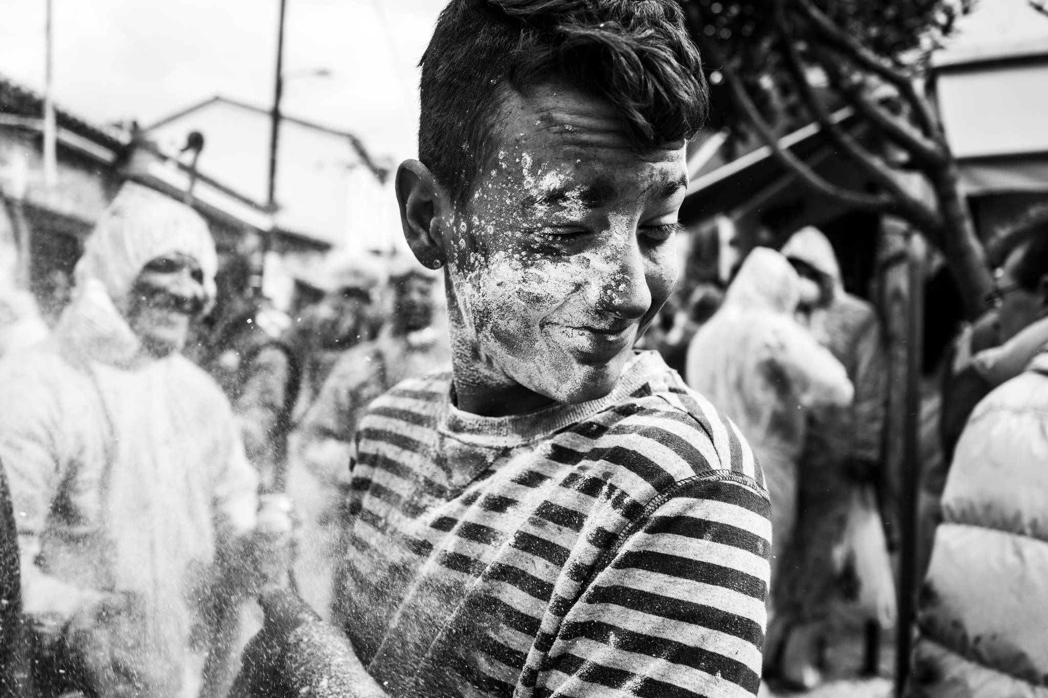 Taking flour in the face at the flour wars of Galaxidi, by photographer George Tatakis