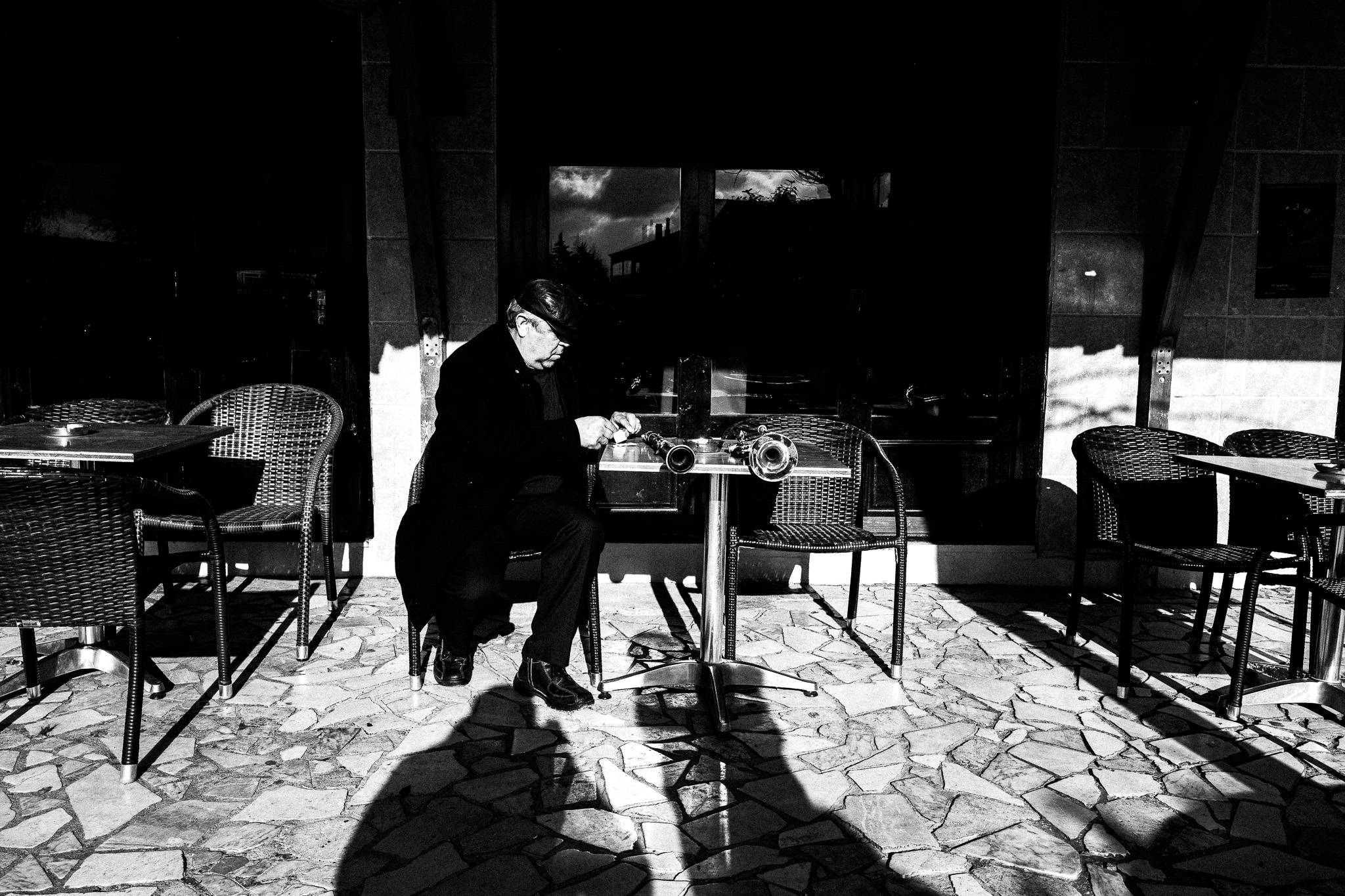 A musician at a local café, before the festivities start, Pagan Christmas customs of Northern Greece, by photographer George Tatakis