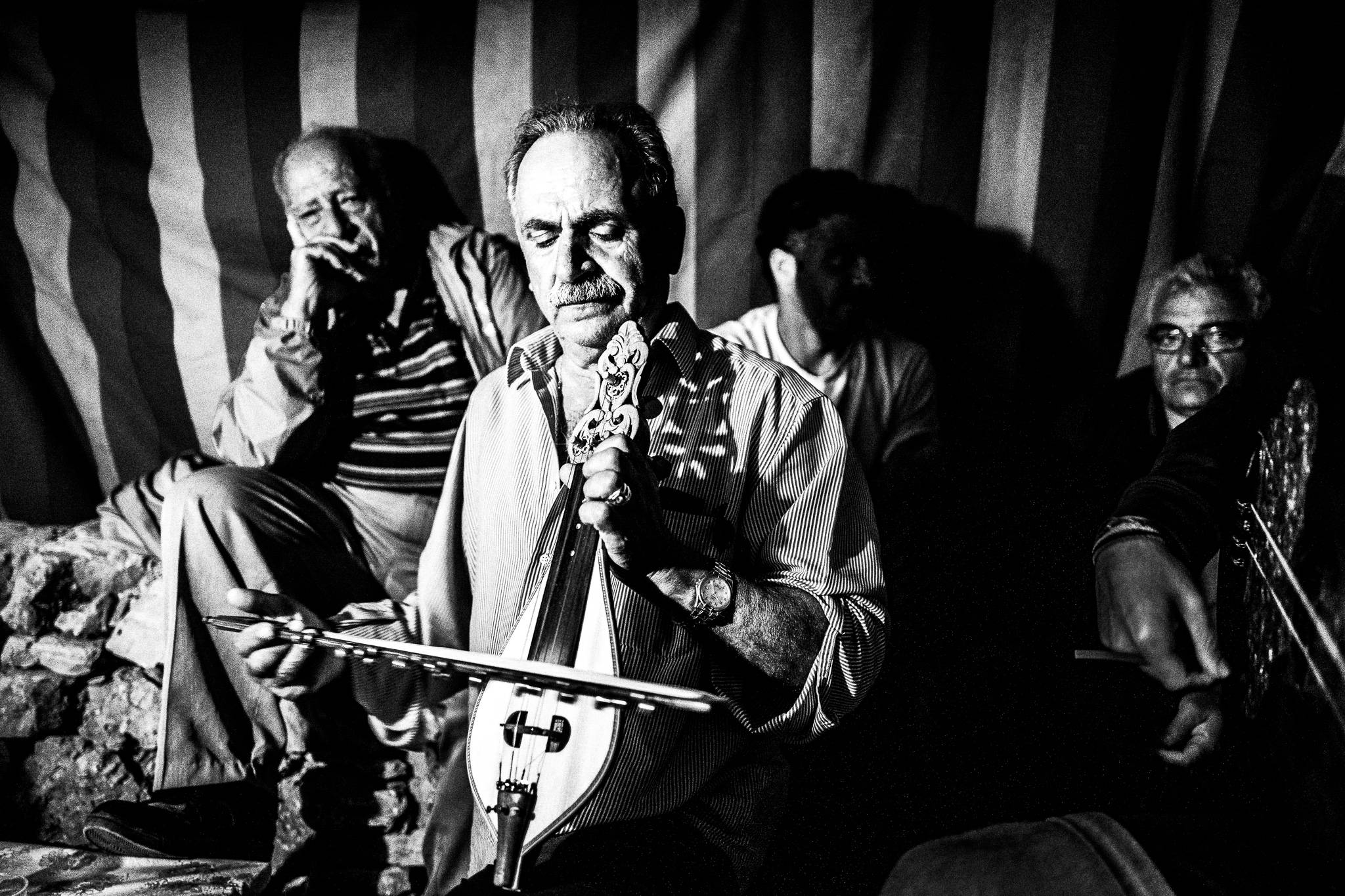 Music for Mantinades during the festival of St. Zacharias at Argos on the island of Saria, Olympos, Karpathos, Greece. Black and white photography by George Tatakis