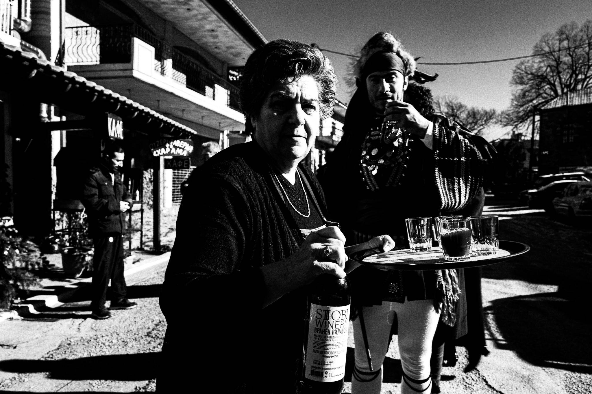 Offering wine to the participants, Pagan Christmas customs of Northern Greece, by photographer George Tatakis