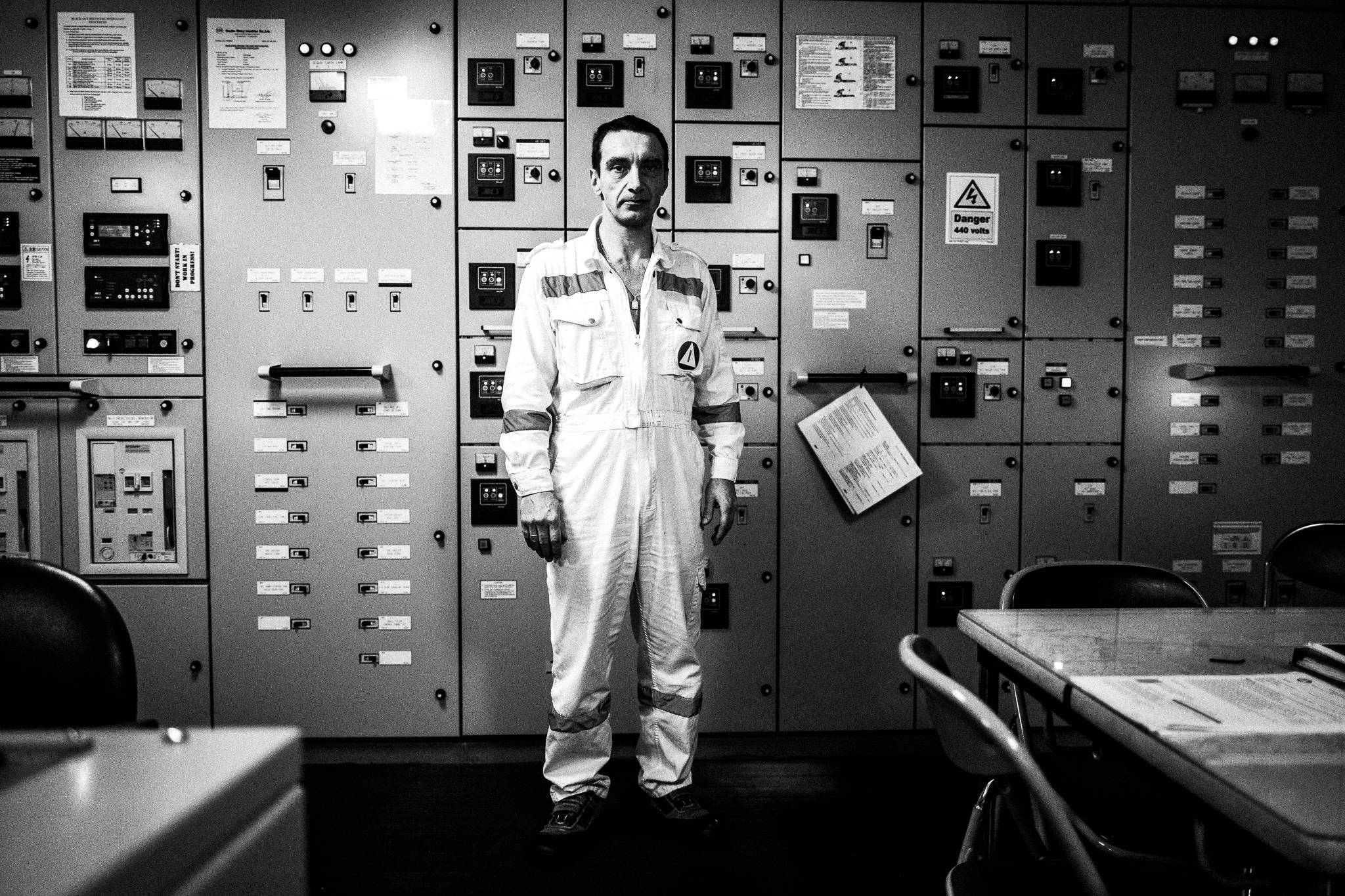 The Chief Engineer by the main panel in the Engine room by photographer George Tatakis