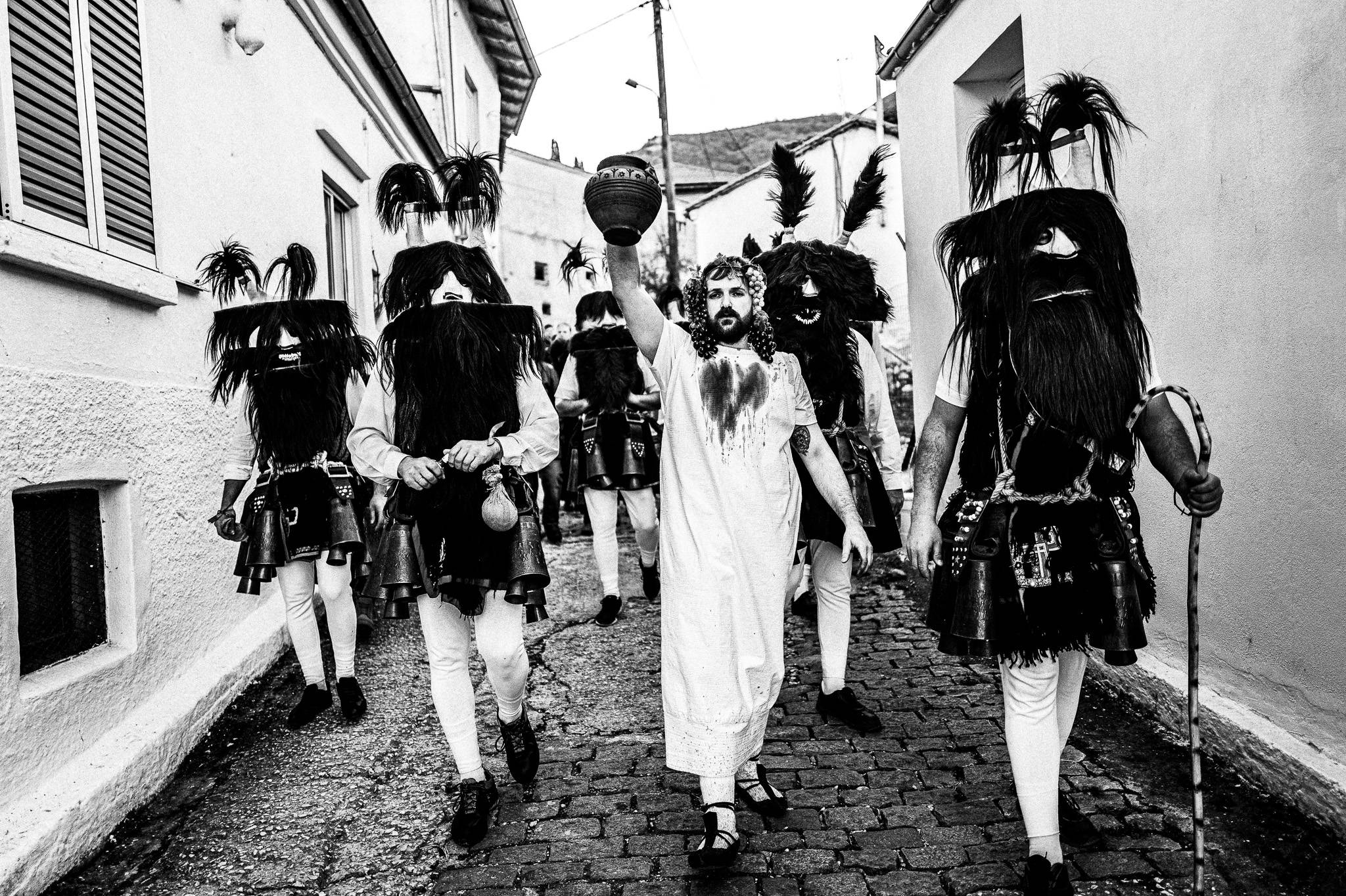 Dionyssus god with wine escorted by Babugera, Pagan Christmas customs of Northern Greece, by photographer George Tatakis