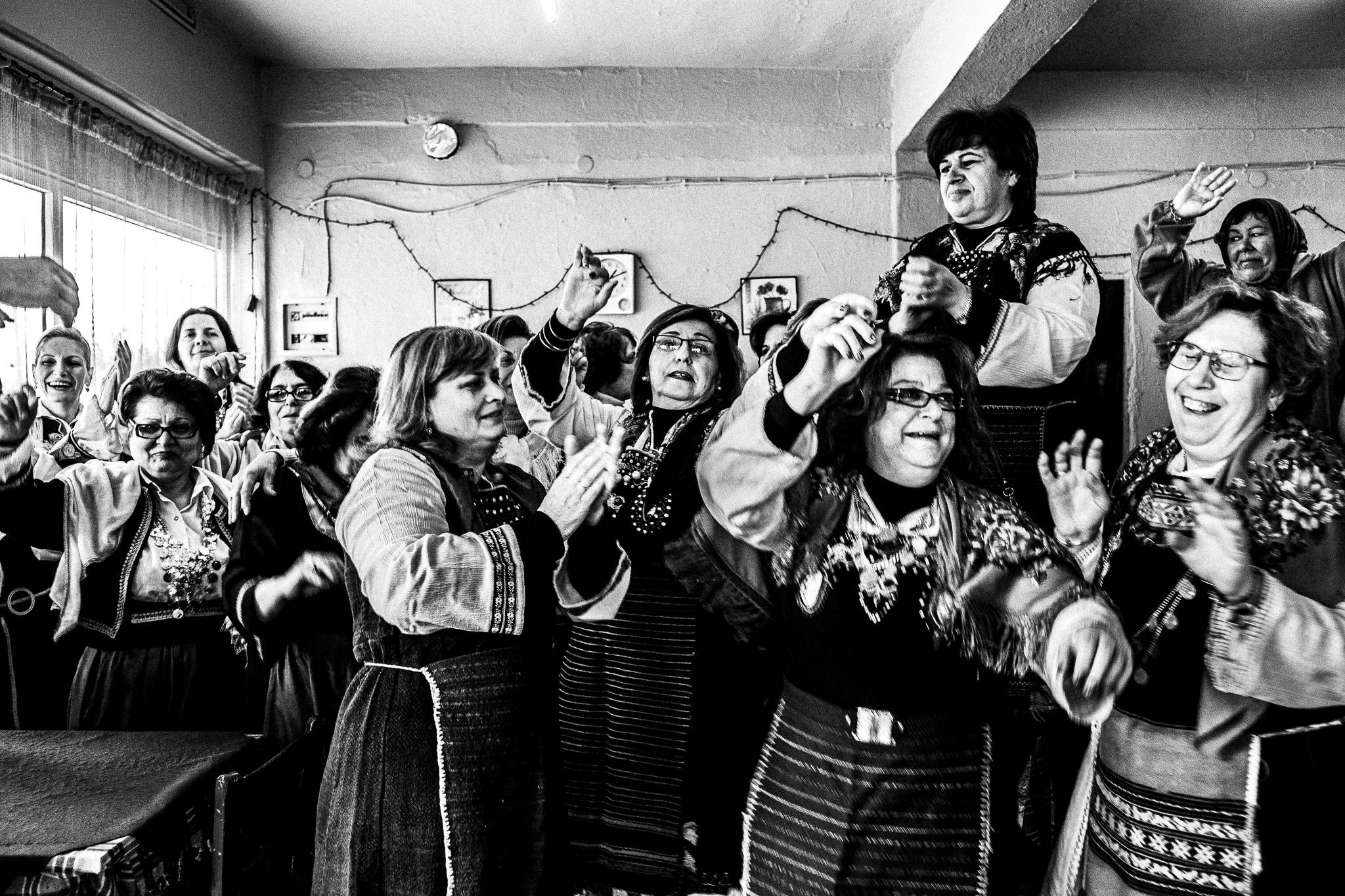 Dancing at the café, Pagan Christmas customs of Northern Greece, by photographer George Tatakis