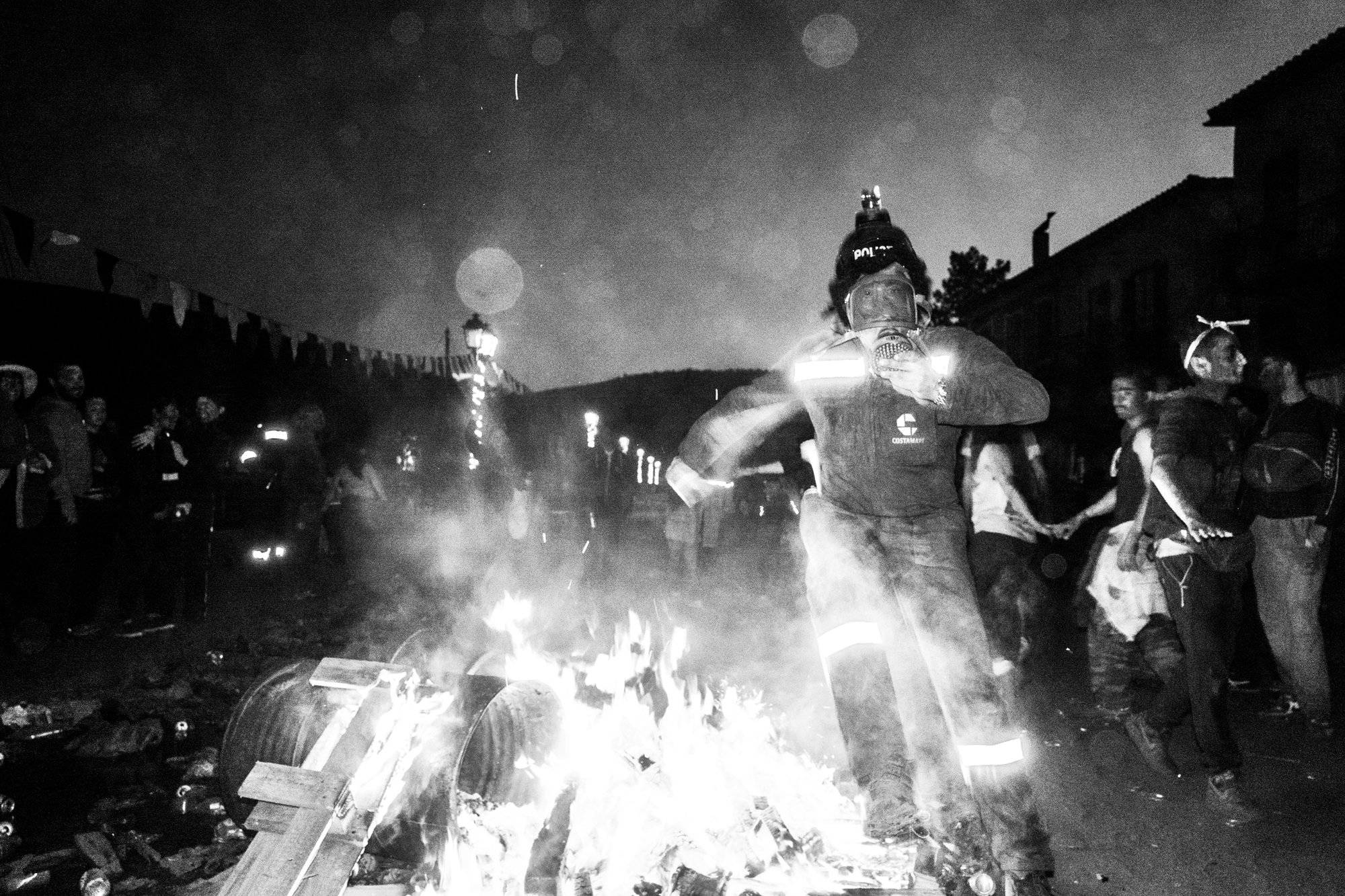 Jumping over a bonfire at the flour wars of Galaxidi, by photographer George Tatakis