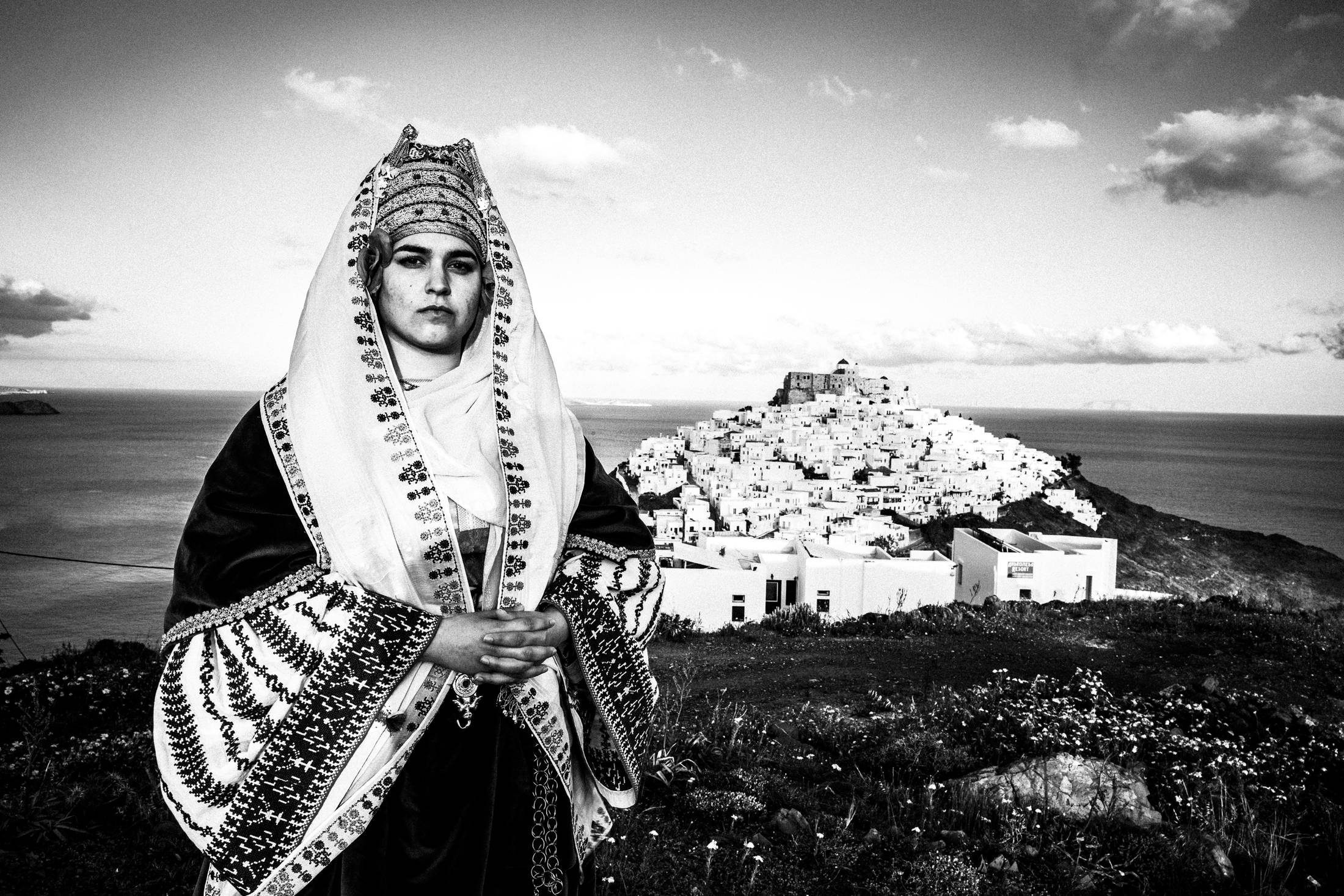 Overlooking the castle and town of Astypalaea in the traditional costume, by photographer George Tatakis