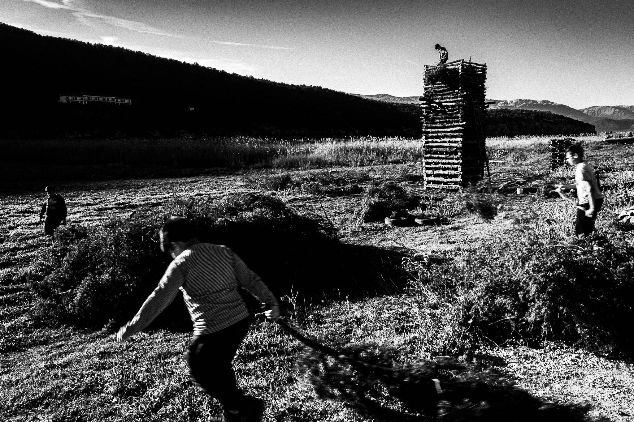 Building up the pile of woods for the bonfire, Pagan Christmas customs of Northern Greece, by photographer George Tatakis