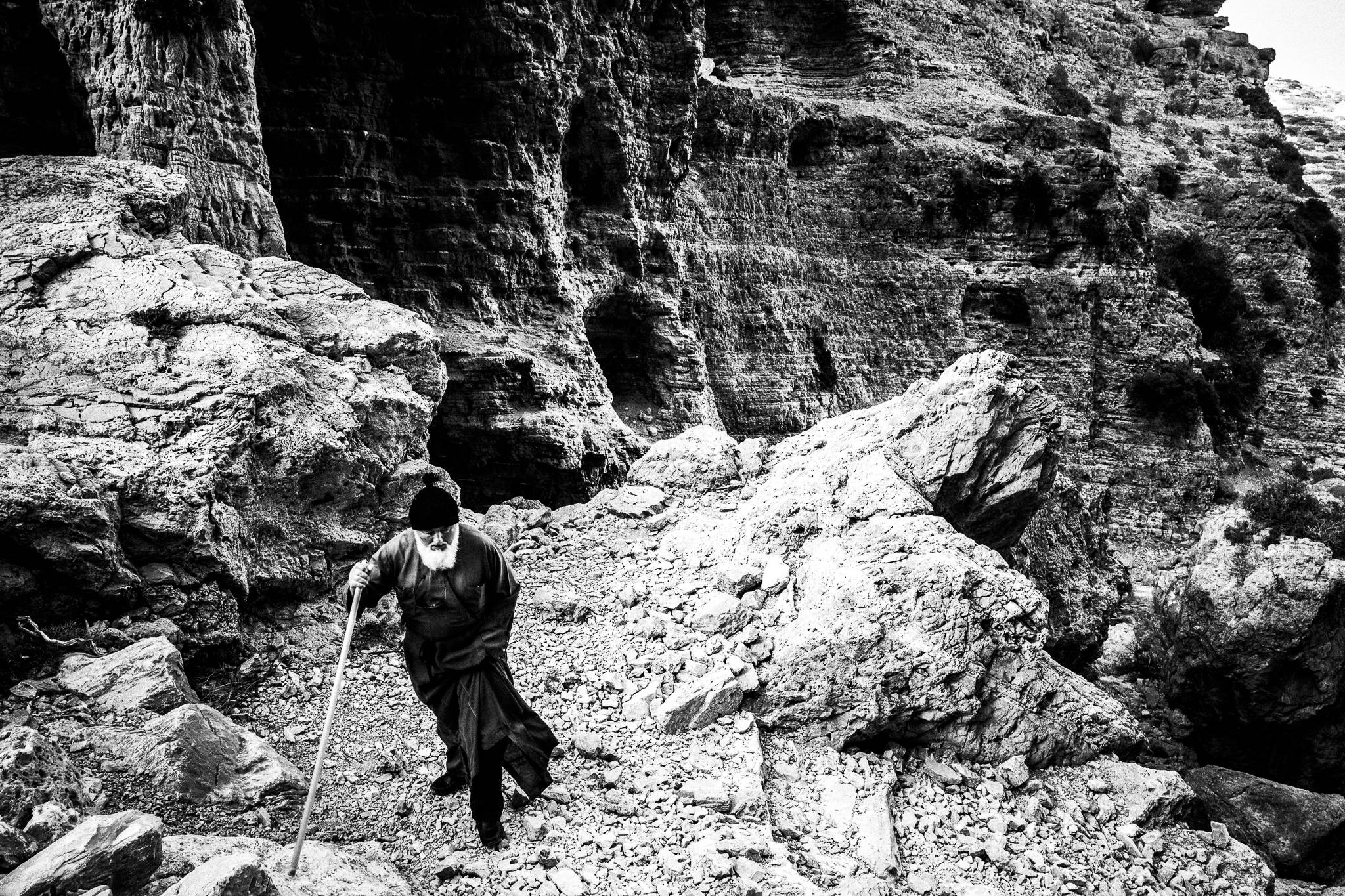 Through the gorge to the festival of St. Zacharias at Argos on the island of Saria, Olympos, Karpathos, Greece. Black and white photography by George Tatakis