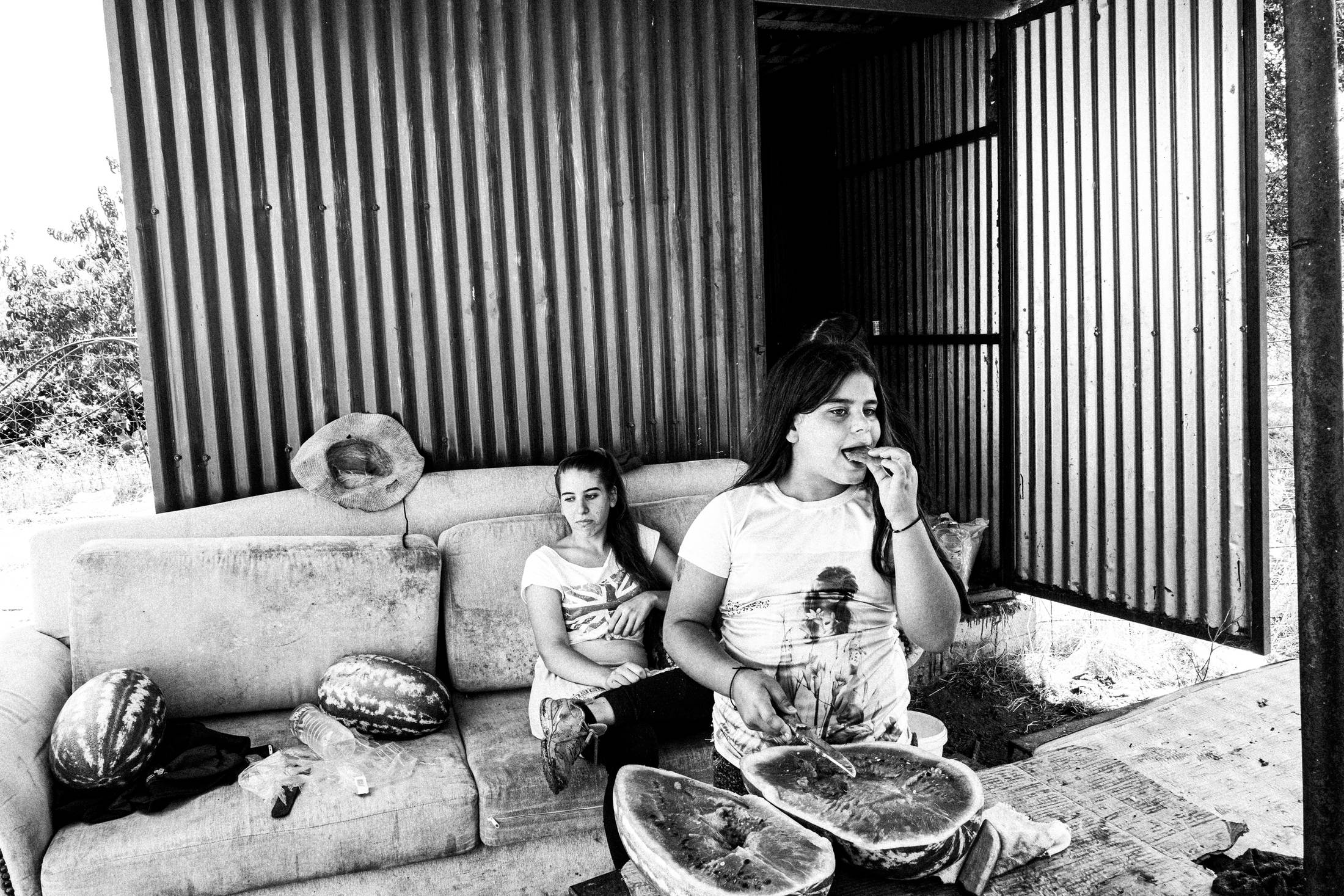 Enjoying watermelon at the local pen, Anogia, Rethymnon, Crete, by photographer George Tatakis