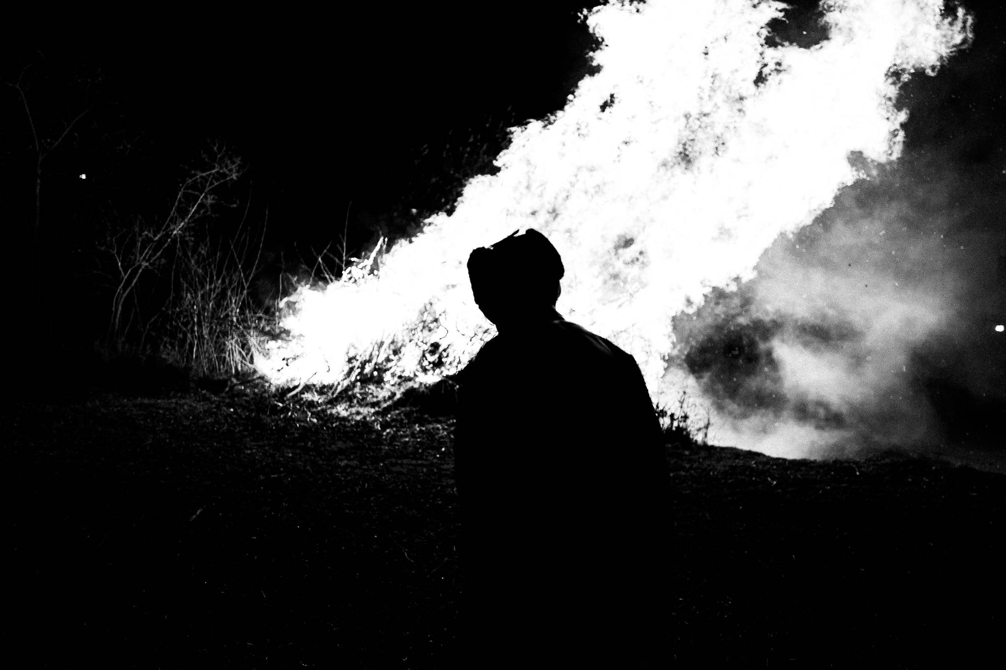 Admiring the bonfire at Giourouki, Pagan Christmas customs of Northern Greece, by photographer George Tatakis