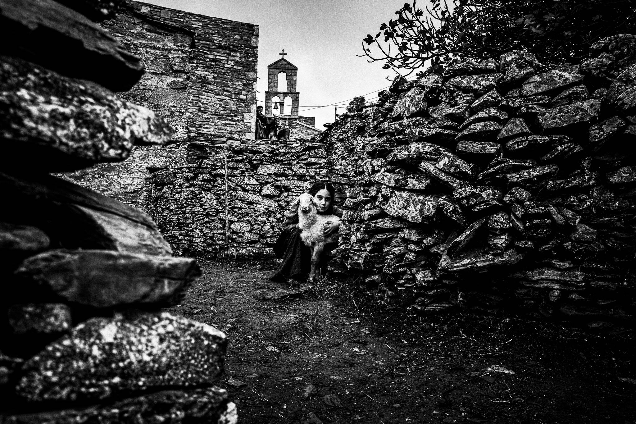 Child with lamb. Black and white photography by George Tatakis during the filming of 'Φόνισσα'(Fonissa).