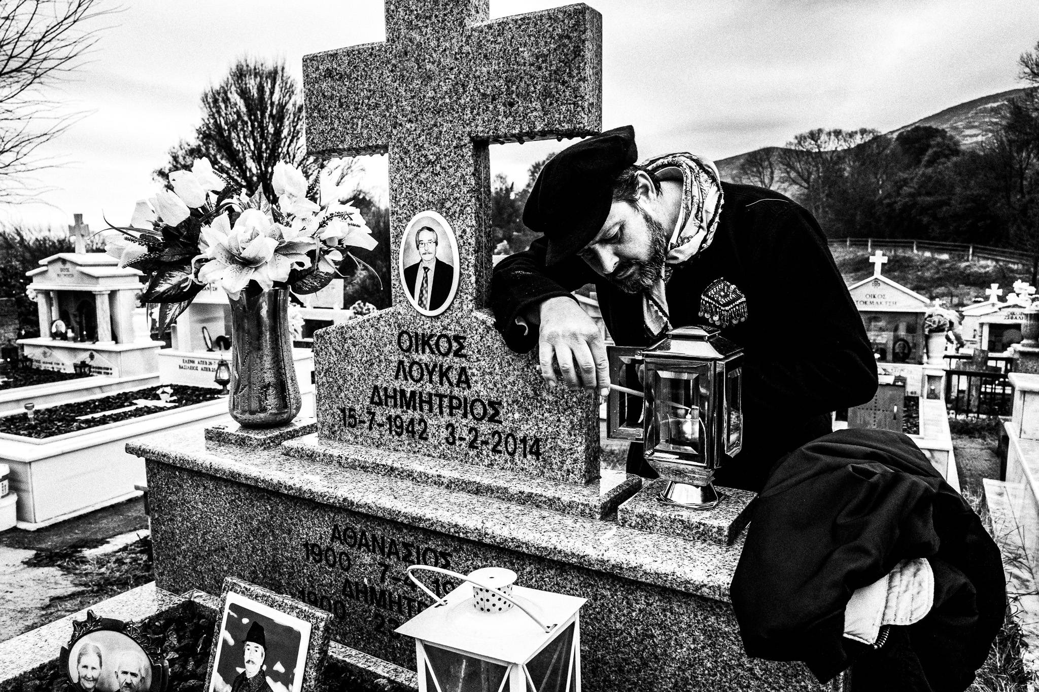Lightring sould burners at the cemetery of Monastiraki, Pagan Christmas customs of Northern Greece, by photographer George Tatakis