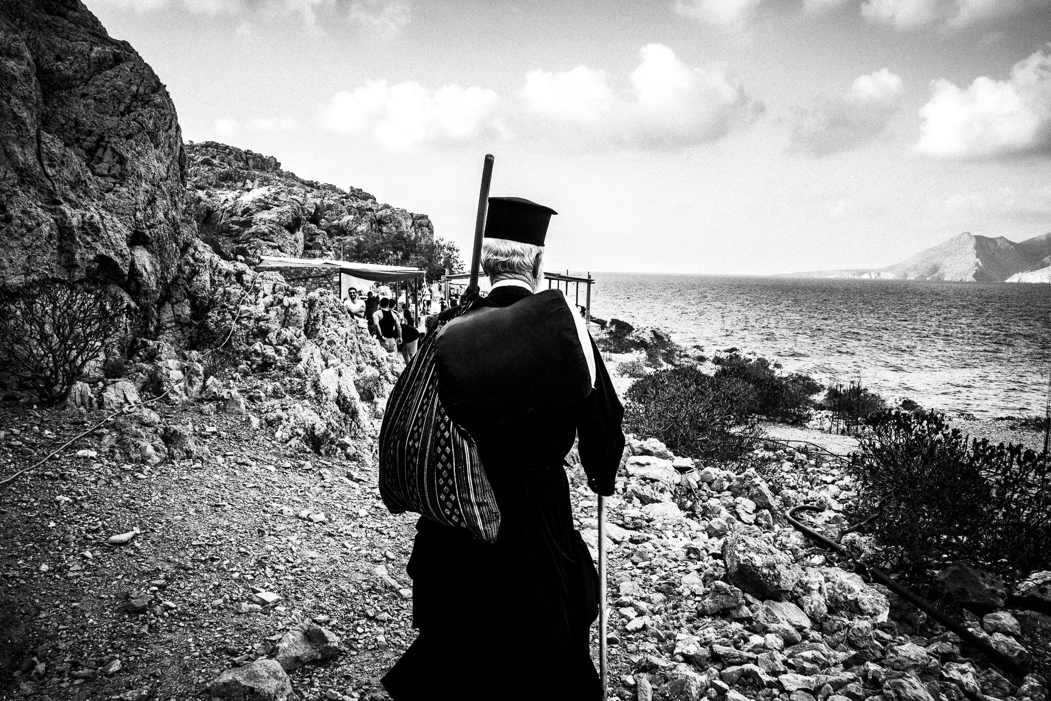 Reaching Brykous, during the feast of Saint John at the site of the ancient city of Brykous, Olympos, Karpathos, Greece. Black and white photography by George Tatakis
