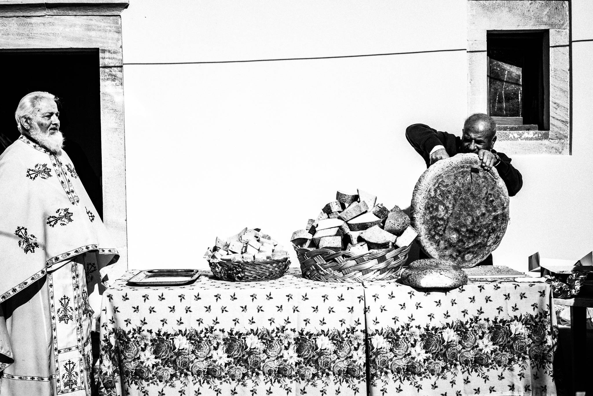 Preparing the Communion bread at the festival of Michael the Archangel at Tristomo, Olympos, Karpathos, Greece. Black and white photography by George Tatakis