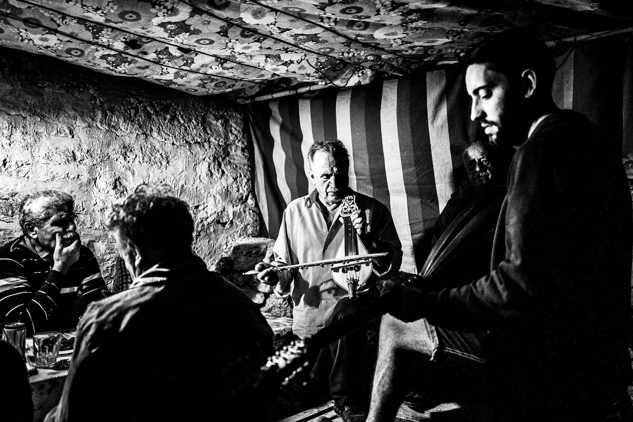 Music around the Glentista'es during the festival of St. Zacharias at Argos on the island of Saria, Olympos, Karpathos, Greece. Black and white photography by George Tatakis