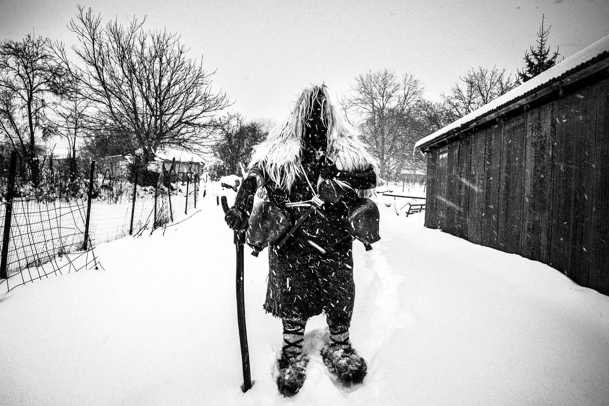 Arapis in the snow, Pagan Christmas customs of Northern Greece, by photographer George Tatakis