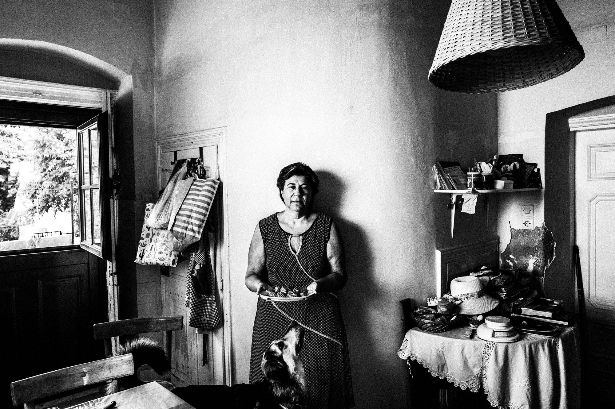 Xanthippi holding a plate of Fylla and Carmella Greece. South Aegean. Kalymnos. © George Tatakis