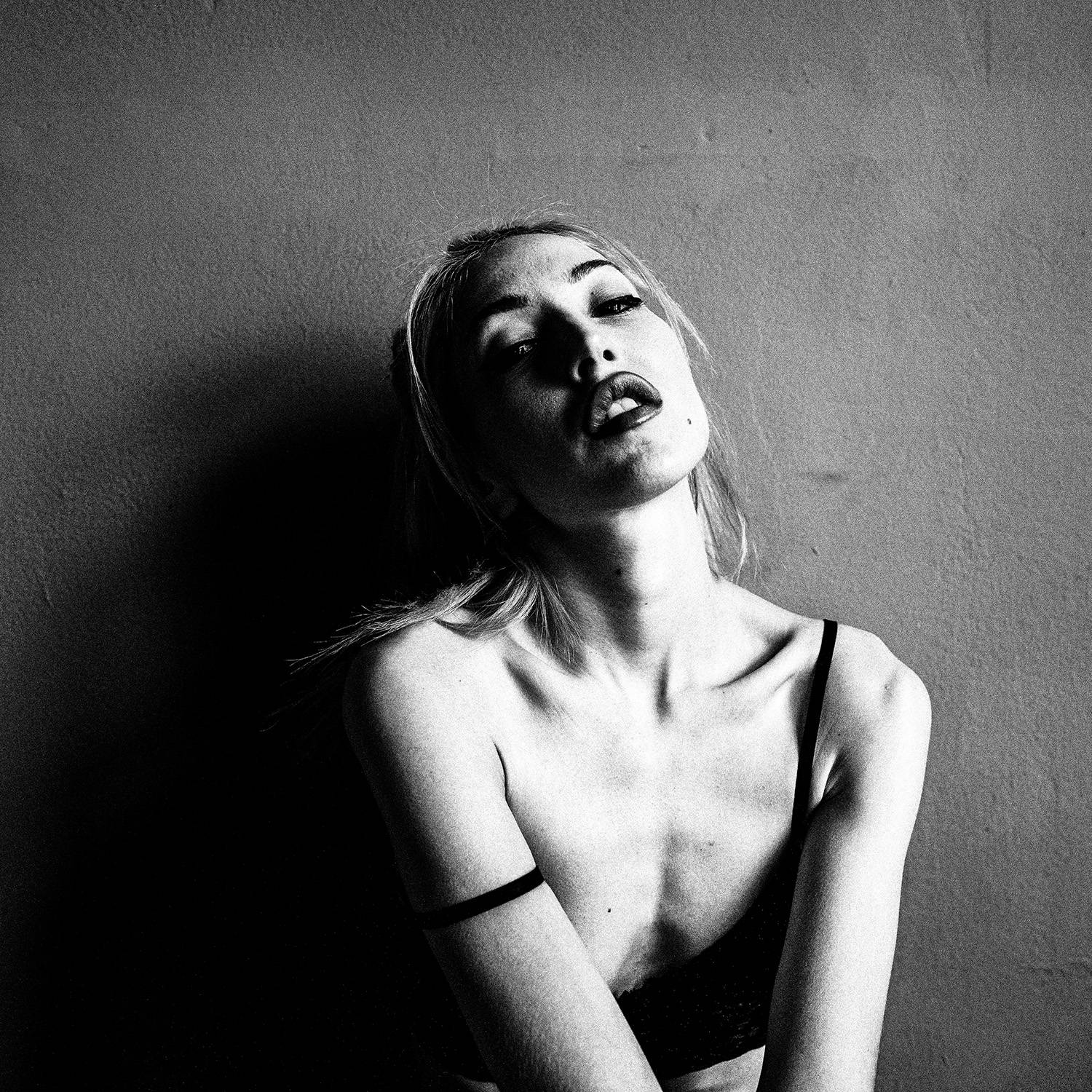 Black and white photograph of a model posing, medium shot