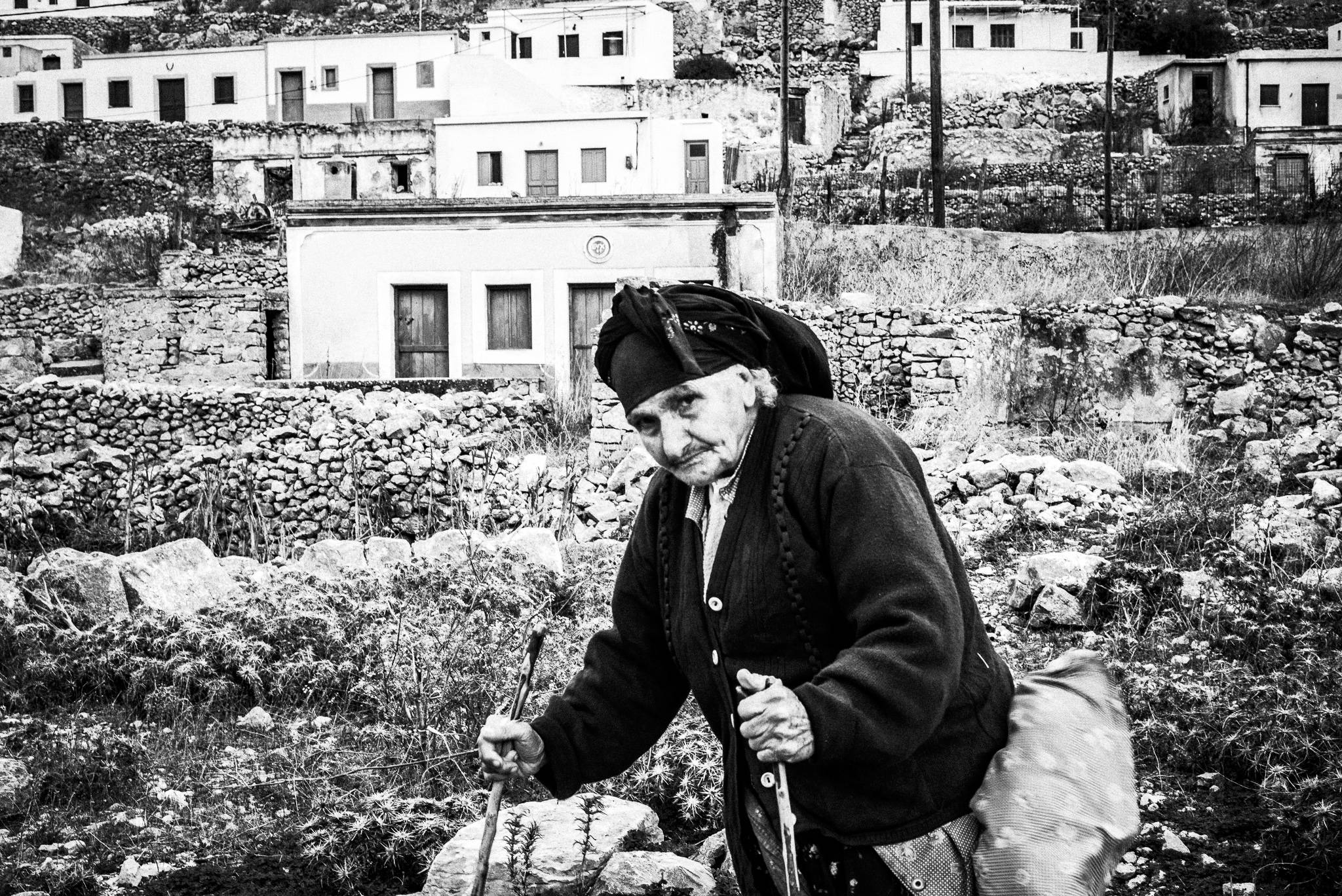 Old lady in Avlona, Olympos, Karpathos, Greece. Black and white photography by George Tatakis