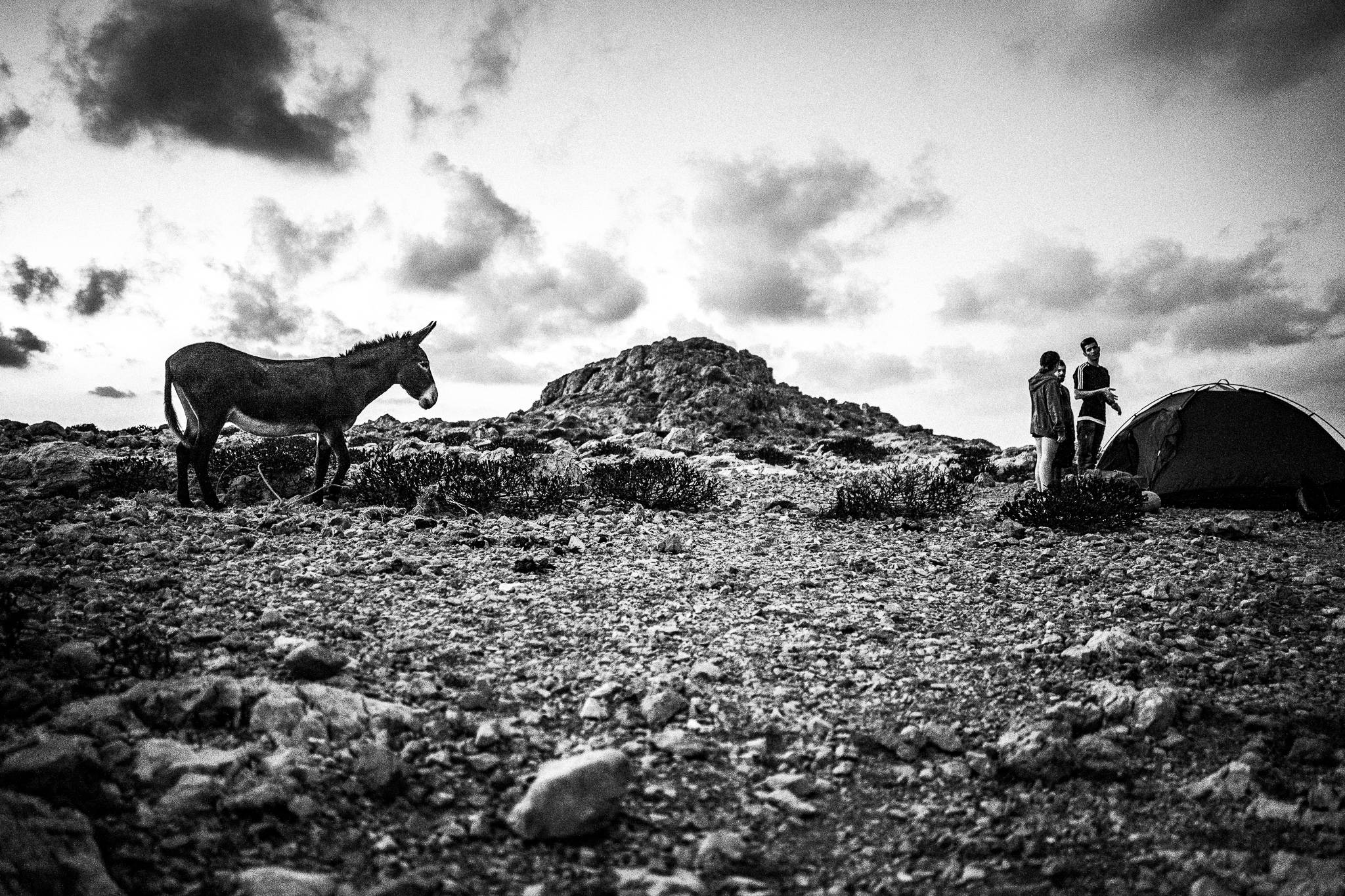 Setting camp at the feast of Saint John at the site of the ancient city of Brykous, Olympos, Karpathos, Greece. Black and white photography by George Tatakis