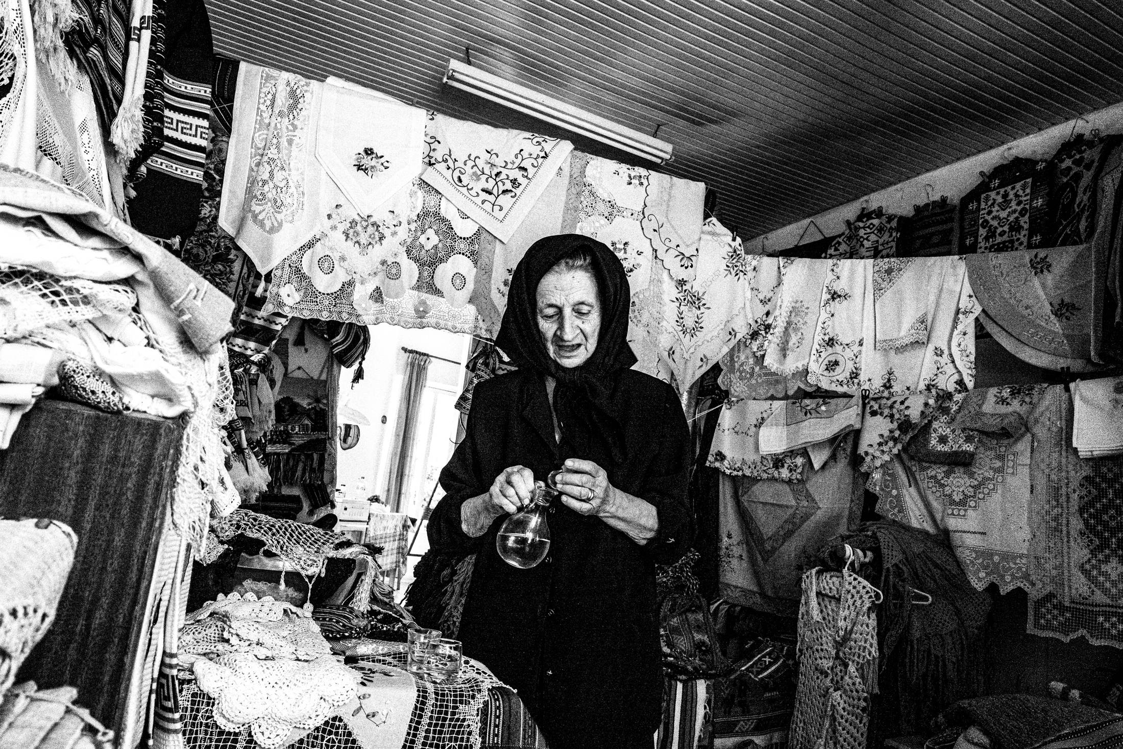 Hermione at her shop in Anogia, Rethymnon, Crete, by photographer George Tatakis
