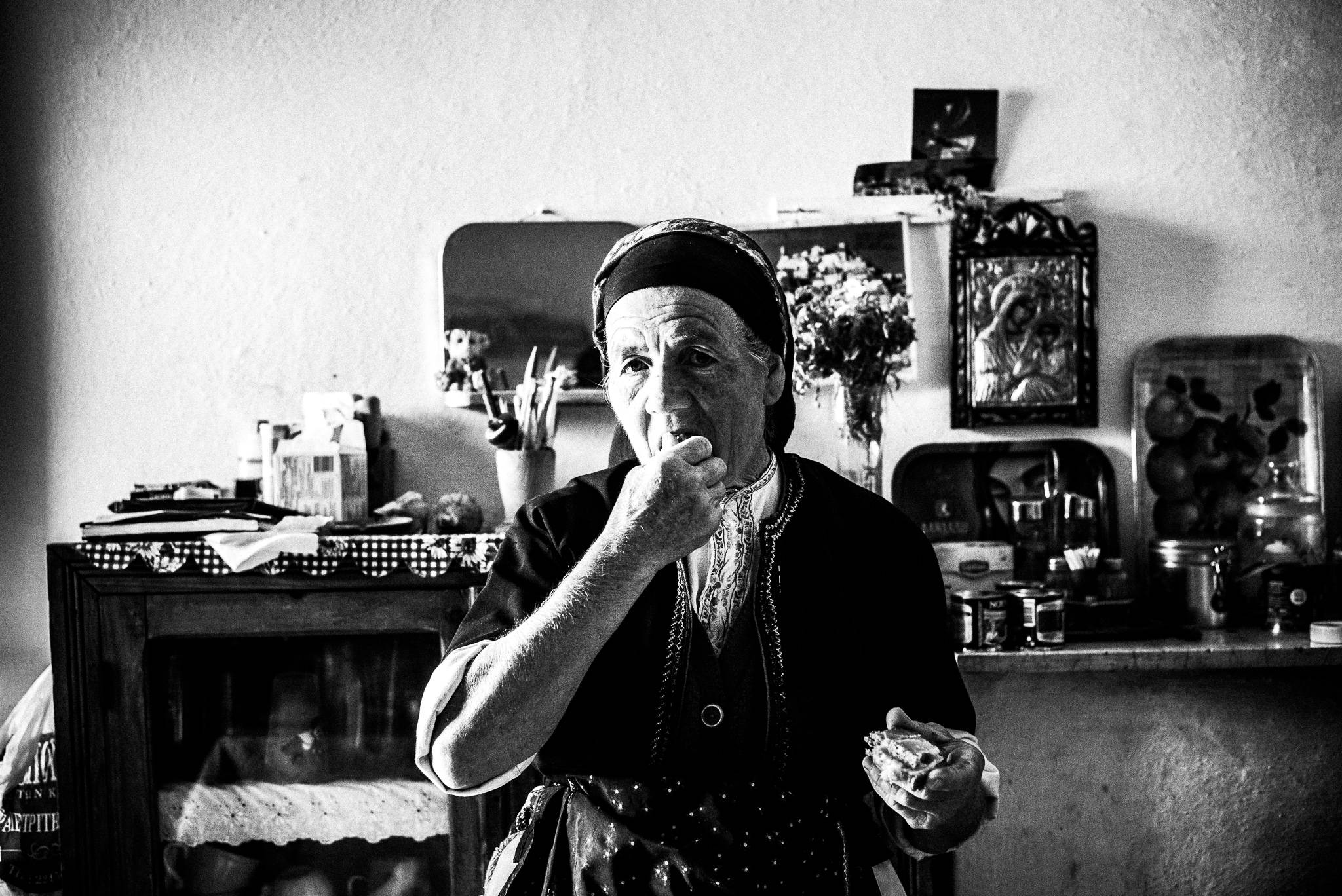 Having a snack , Olympos, Karpathos, Greece. Black and white photography by George Tatakis
