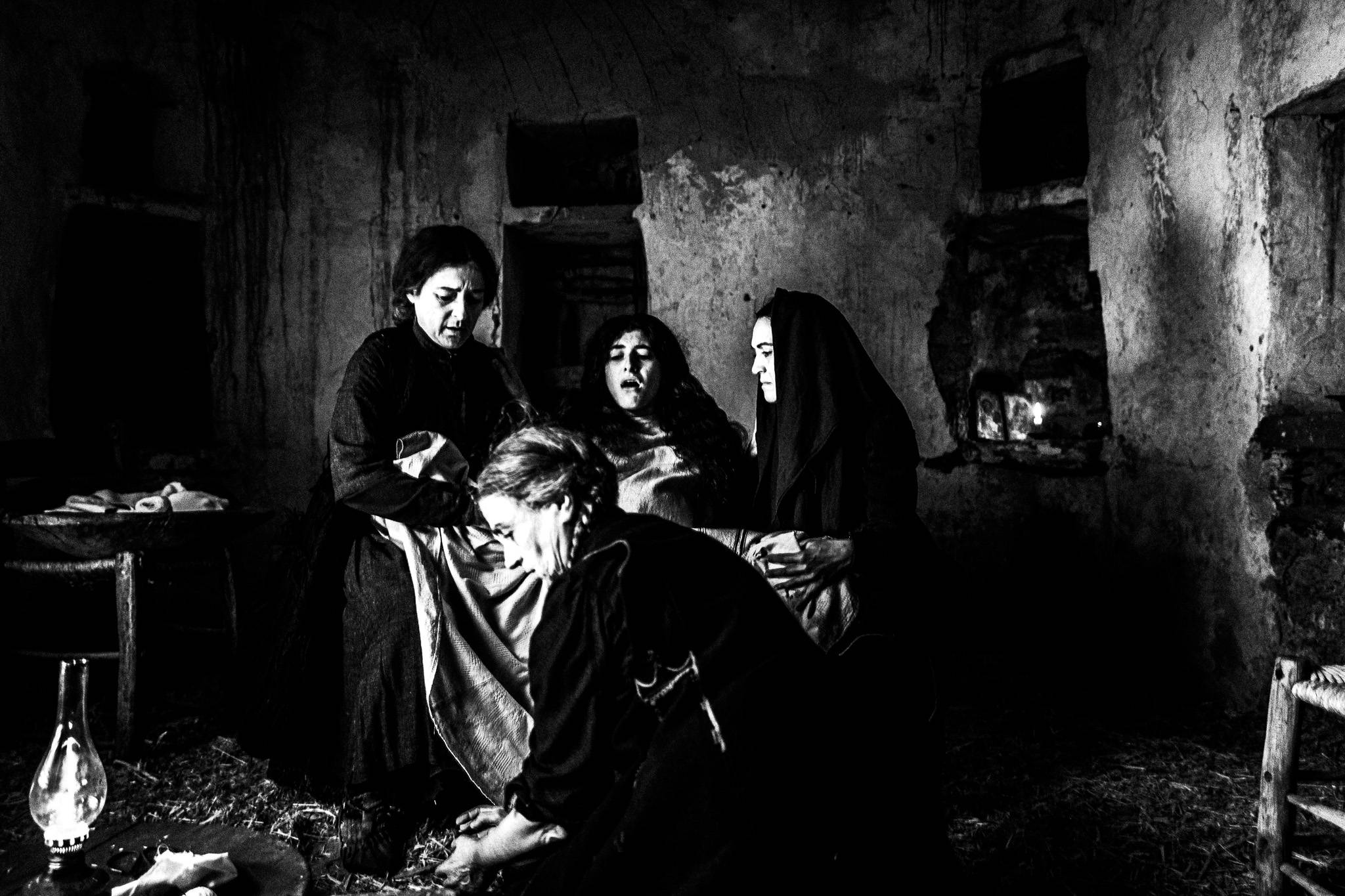 The Fonissa delivering a baby. Black and white photography by George Tatakis during the filming of 'Φόνισσα'(Fonissa).