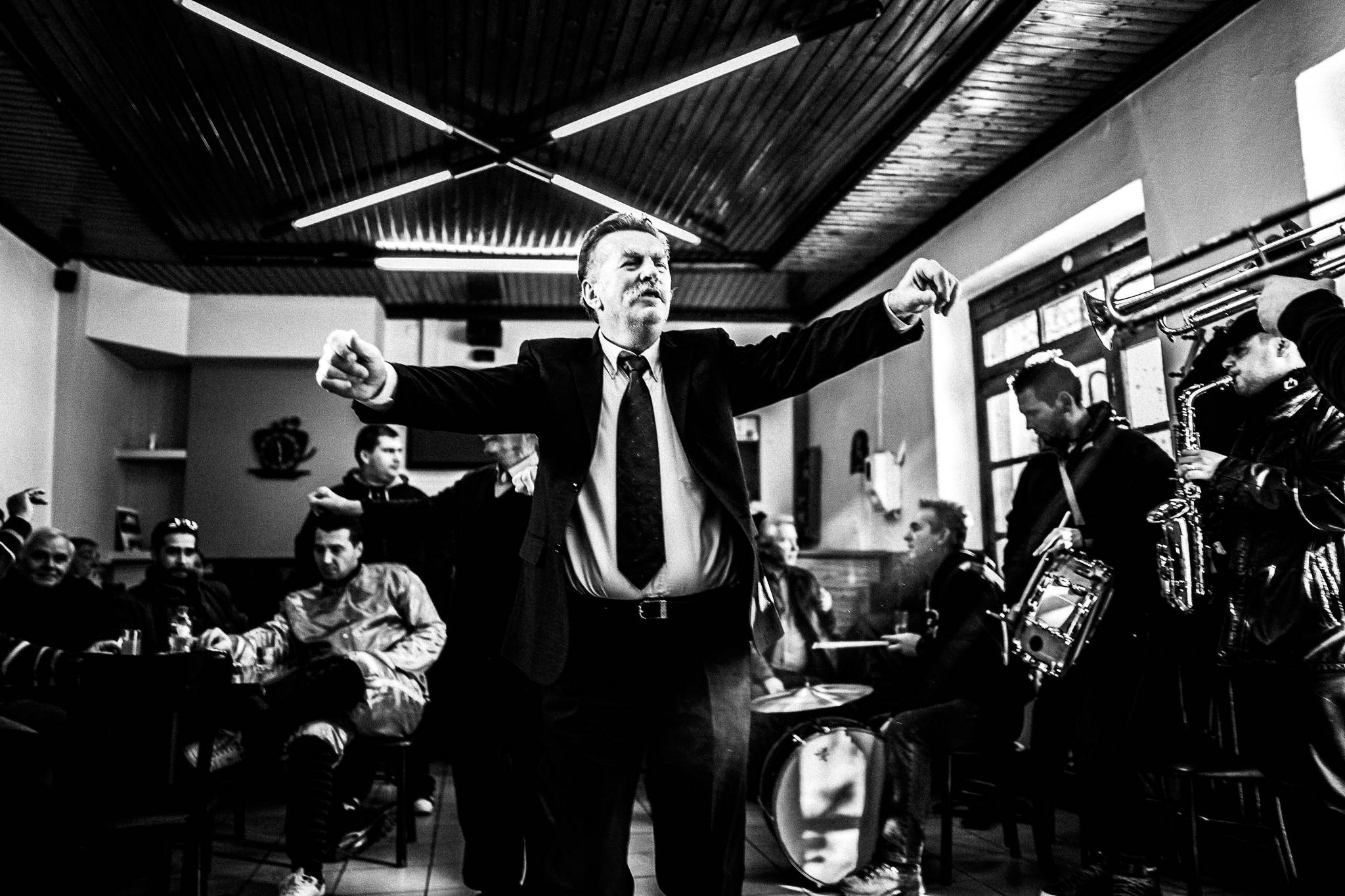 Dancing inside the café, Pagan Christmas customs of Northern Greece, by photographer George Tatakis