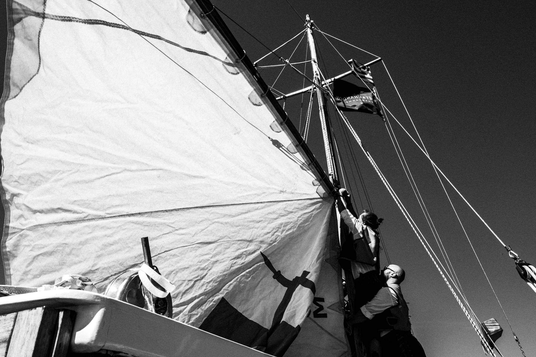 Opening the sails of the sailboat, by photographer George Tatakis