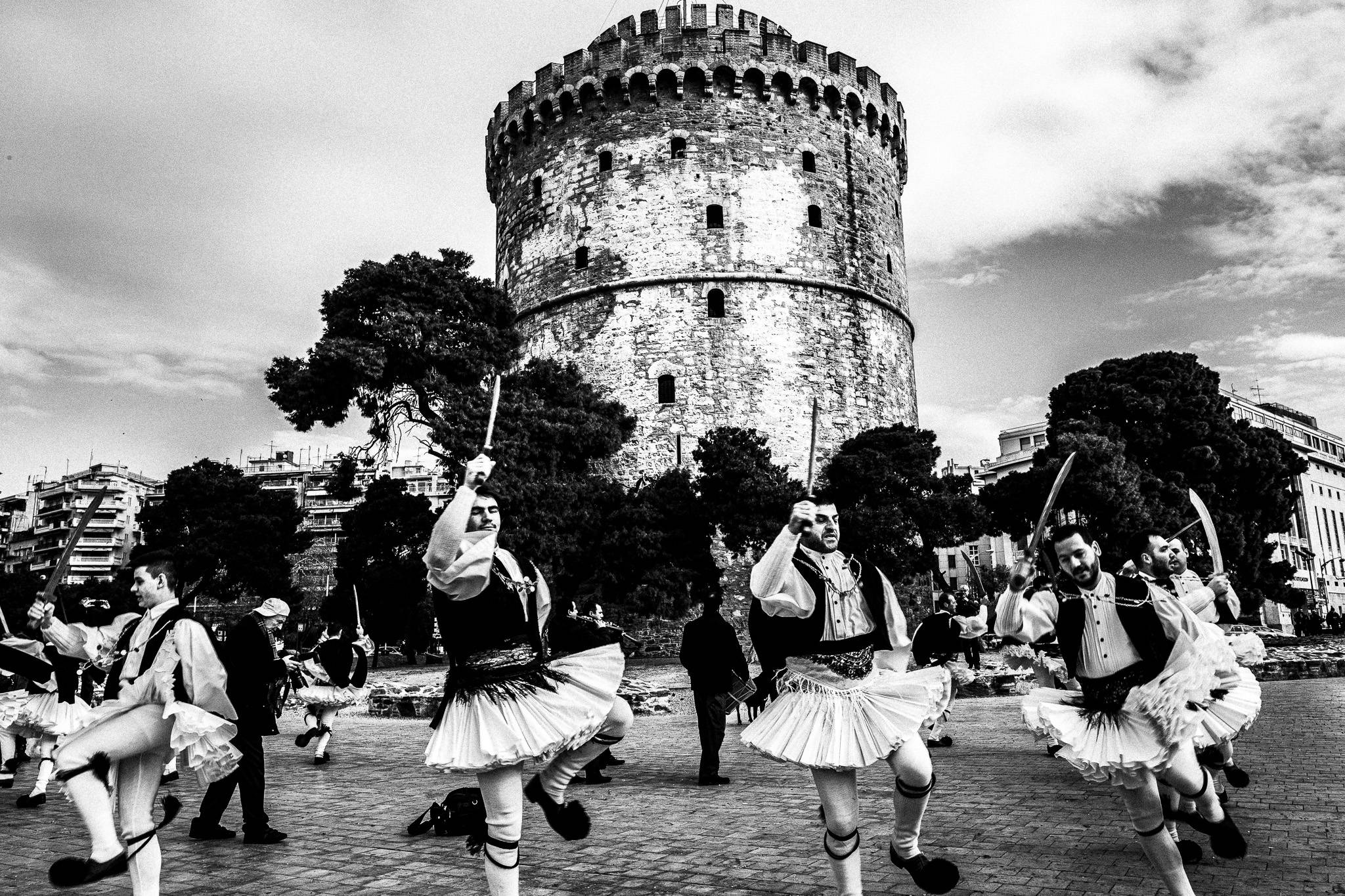 Fotarades dancing at Thessaloniki, in front of the White Tower, Pagan Christmas customs of Northern Greece, by photographer George Tatakis