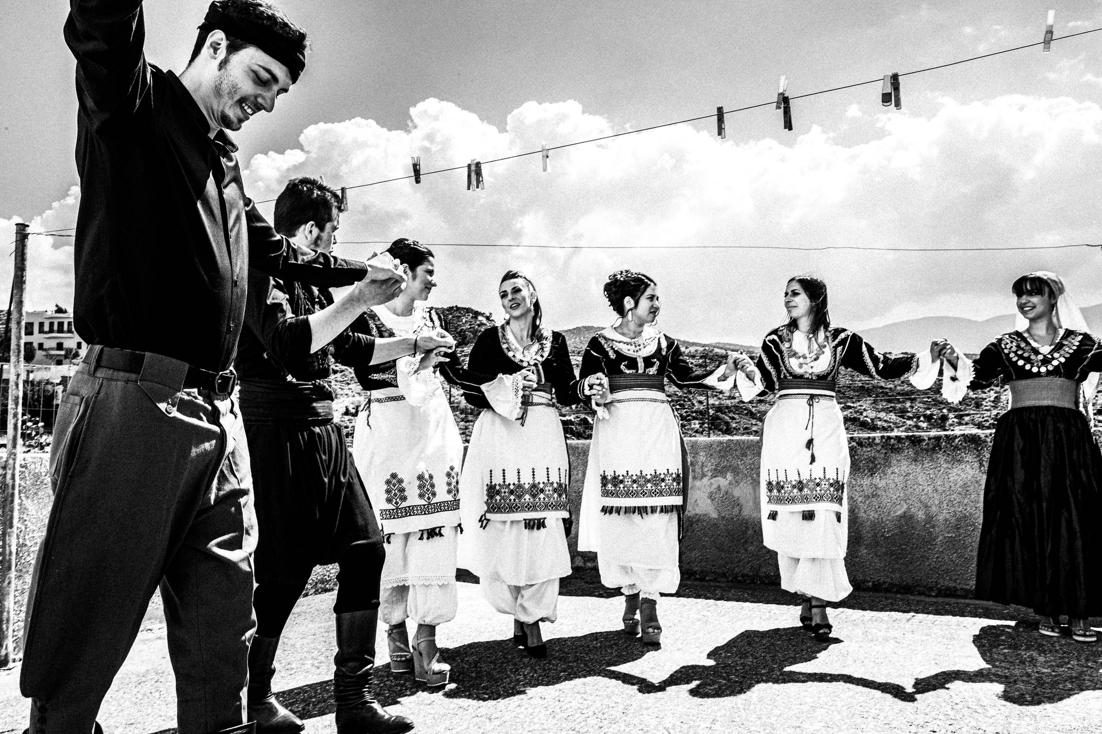 Dancing atop a roof before the wedding, Anogia, Rethymnon, Crete, by photographer George Tatakis