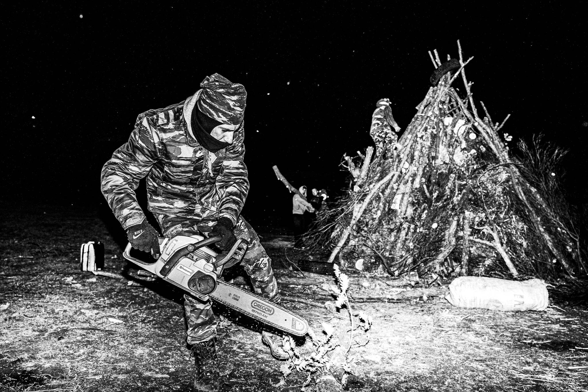 Final touches during nightfall, Pagan Christmas customs of Northern Greece, by photographer George Tatakis
