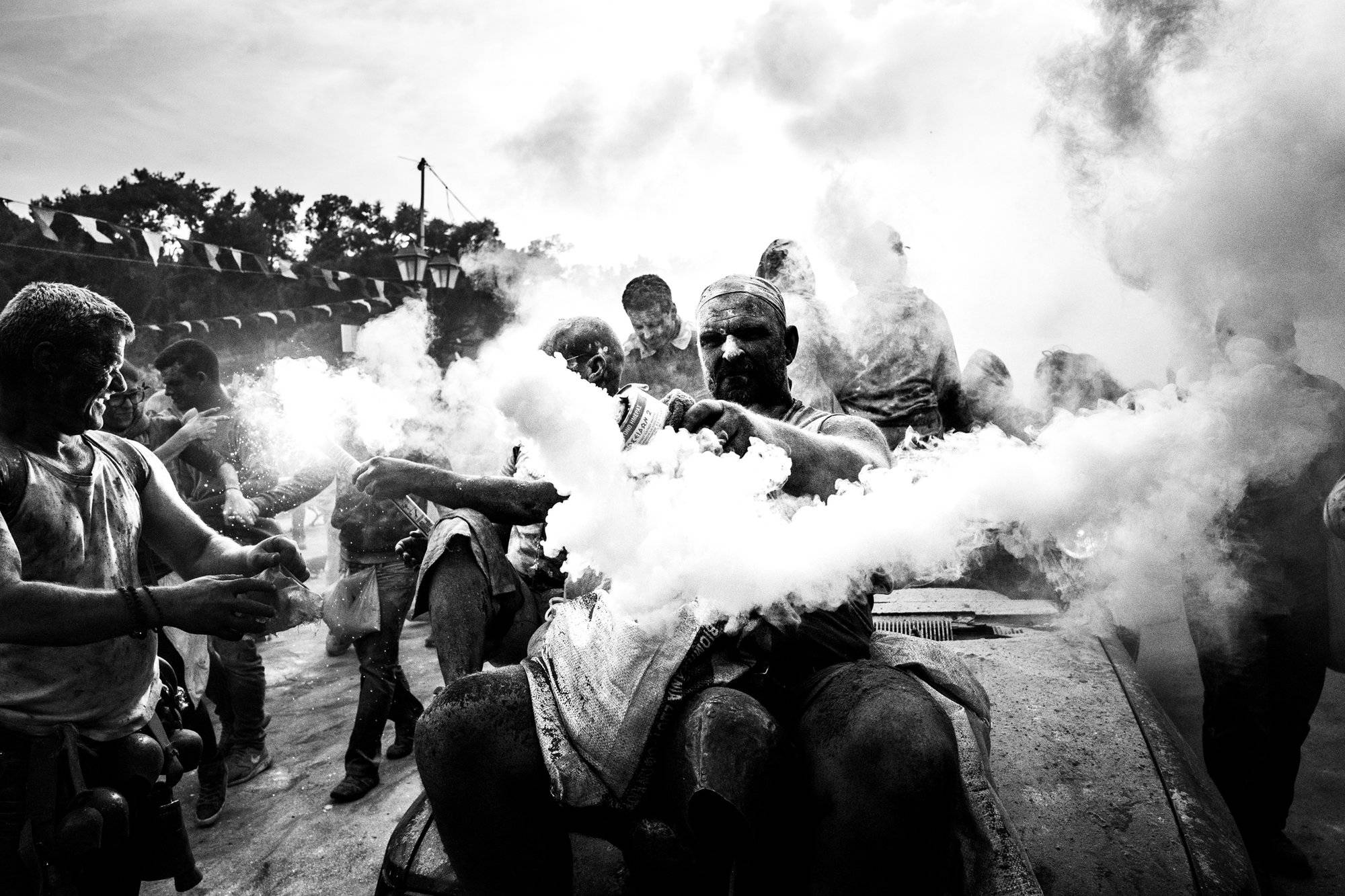 Smoke cans and cars at the flour wars of Galaxidi, by photographer George Tatakis