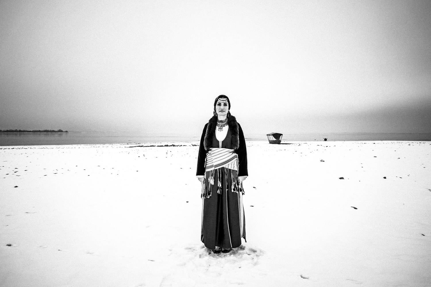 A woman wearing the traditional Pontic costume at lake Kerkini, Macedonia, Greece. Black and white photograph by George Tatakis