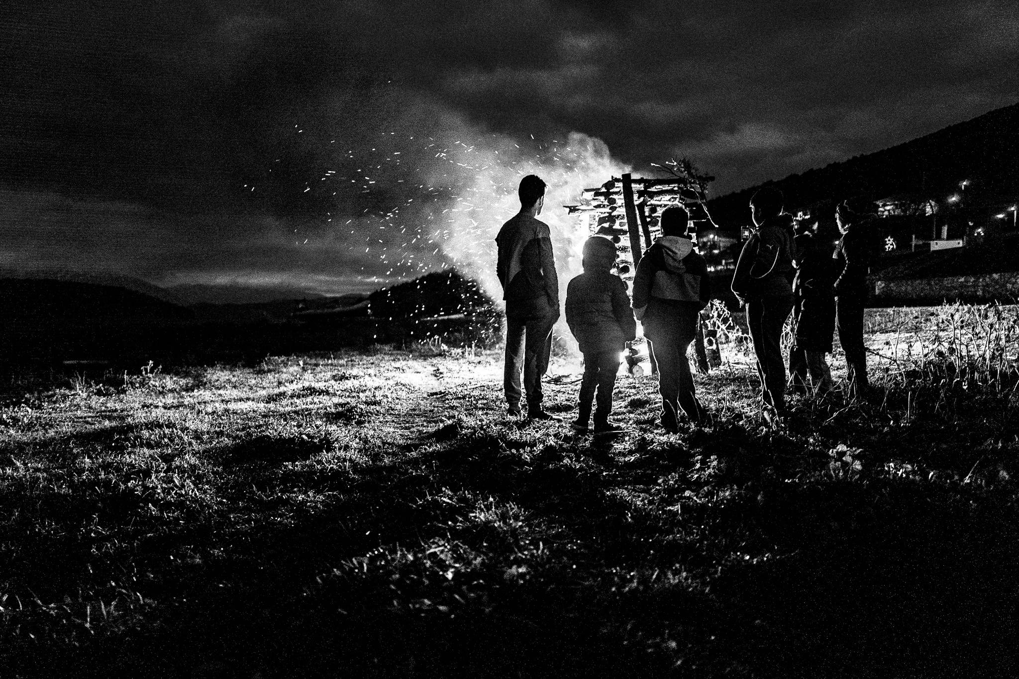 Enjoying the warmth by the bonfire, Pagan Christmas customs of Northern Greece, by photographer George Tatakis