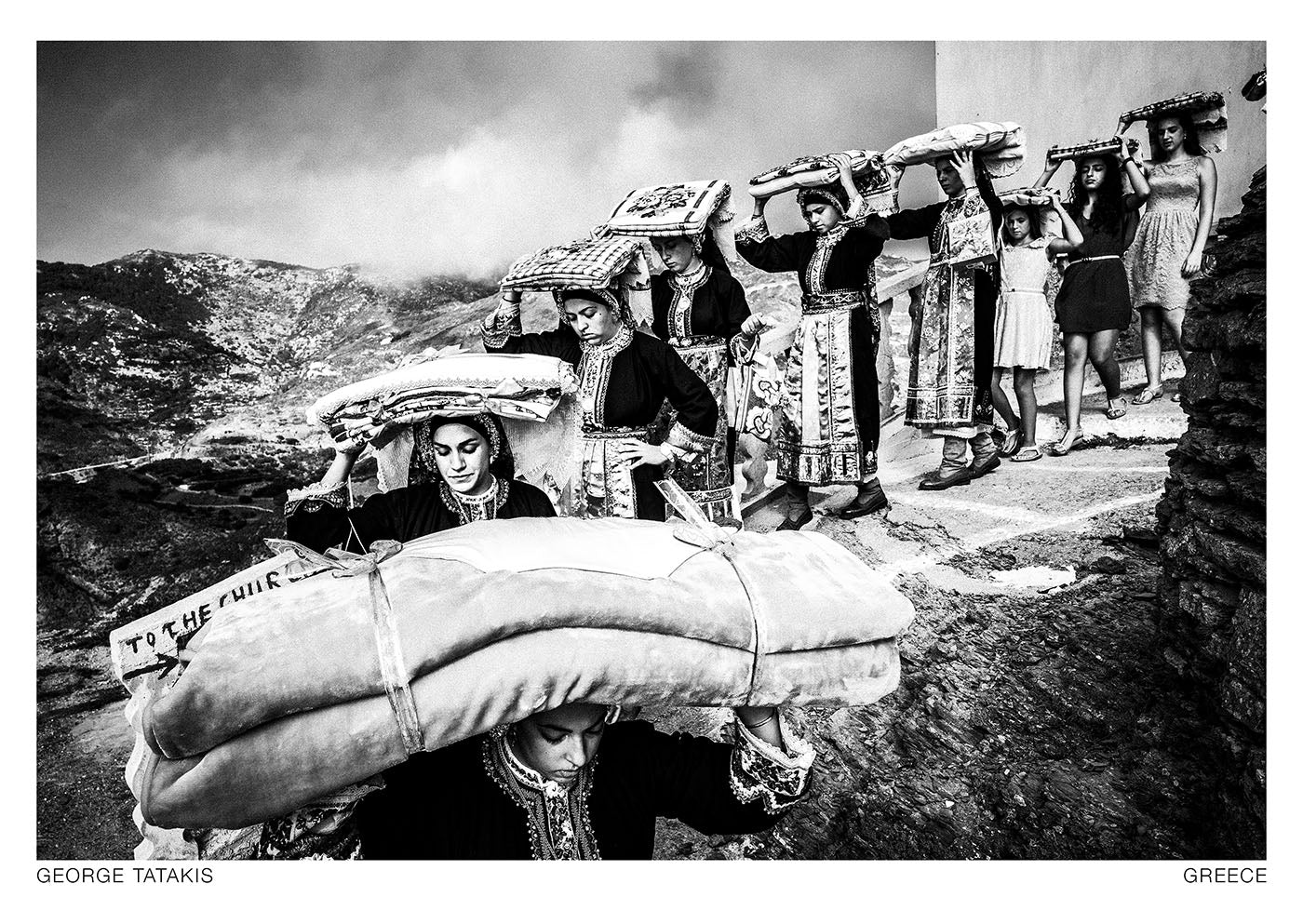 Women transporting dowry in Olympos, Karpathos, Greece. Black and white photography postcard by George Tatakis, project Ethos.